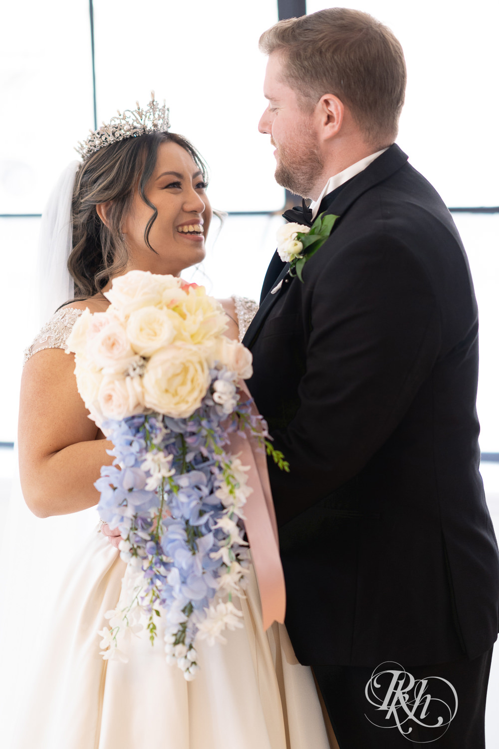 Hmong bride and groom share first look on wedding day at the Saint Paul Athletic Club in Saint Paul, Minnesota.