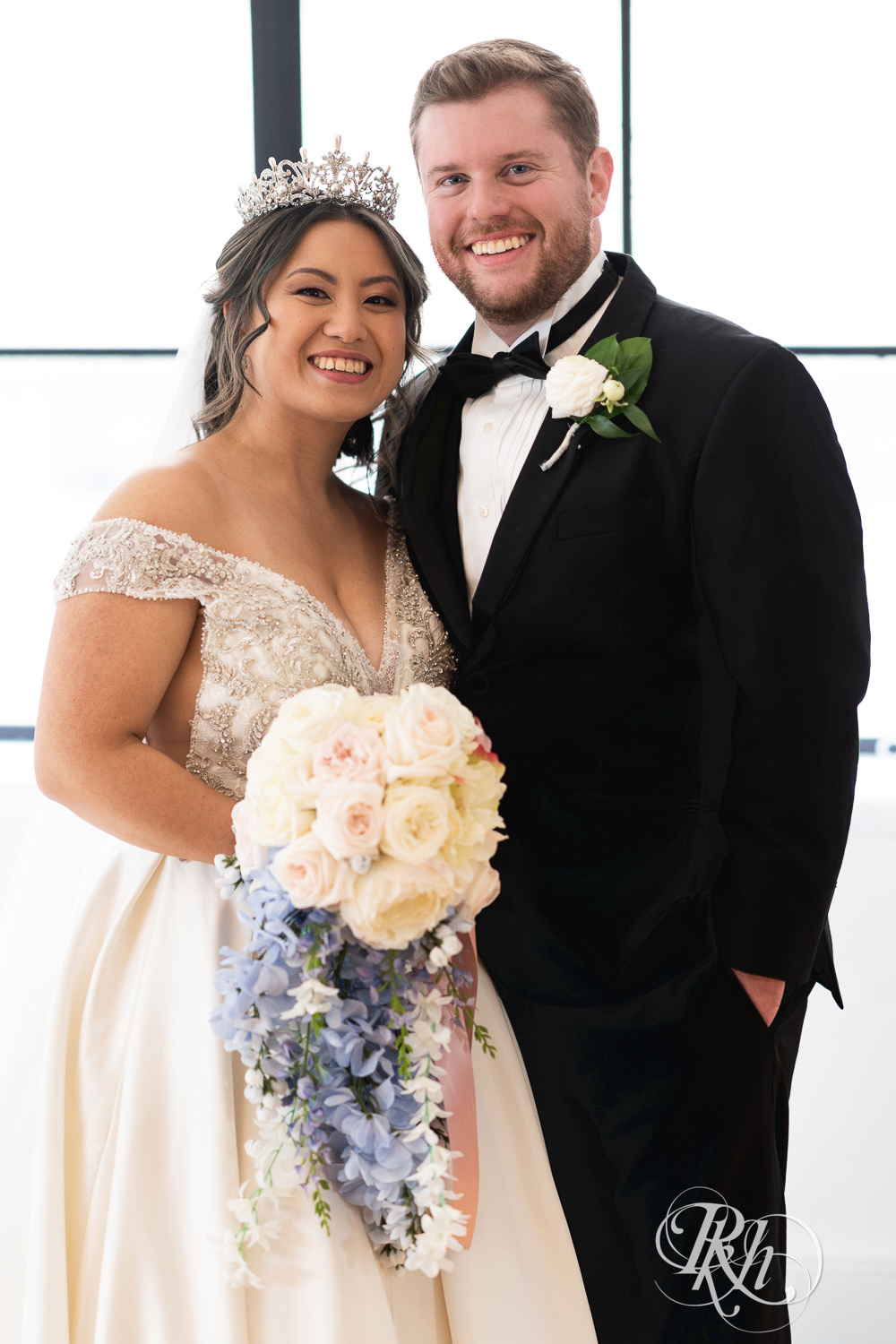 Hmong bride and groom smile on wedding day at the Saint Paul Athletic Club in Saint Paul, Minnesota.