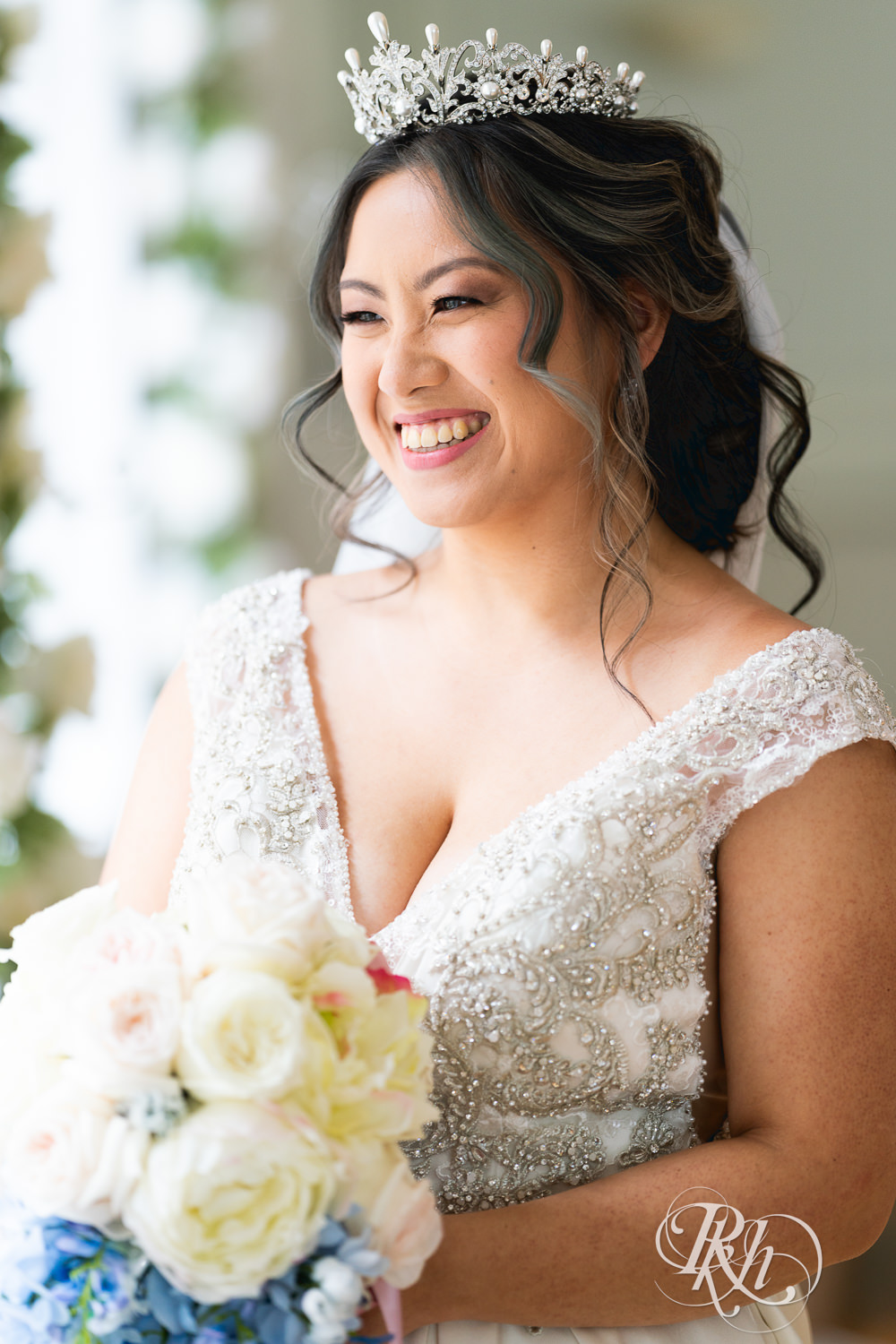 Hmong bride smiles on wedding day at the Saint Paul Athletic Club in Saint Paul, Minnesota.