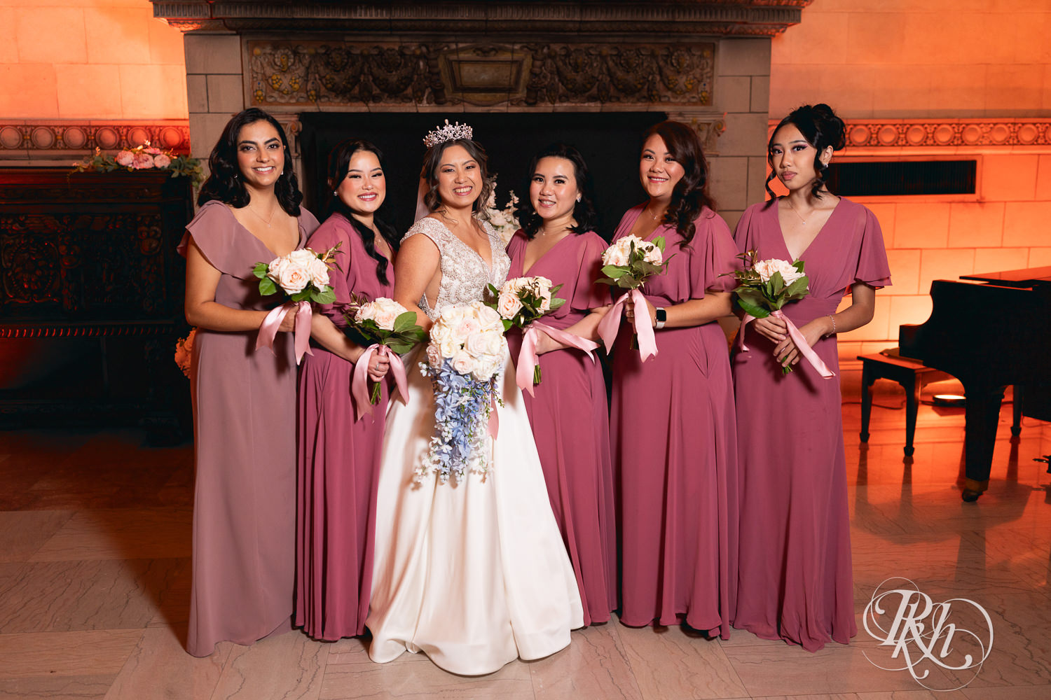 Hmong bride smiles with wedding party at the Saint Paul Athletic Club in Saint Paul, Minnesota.