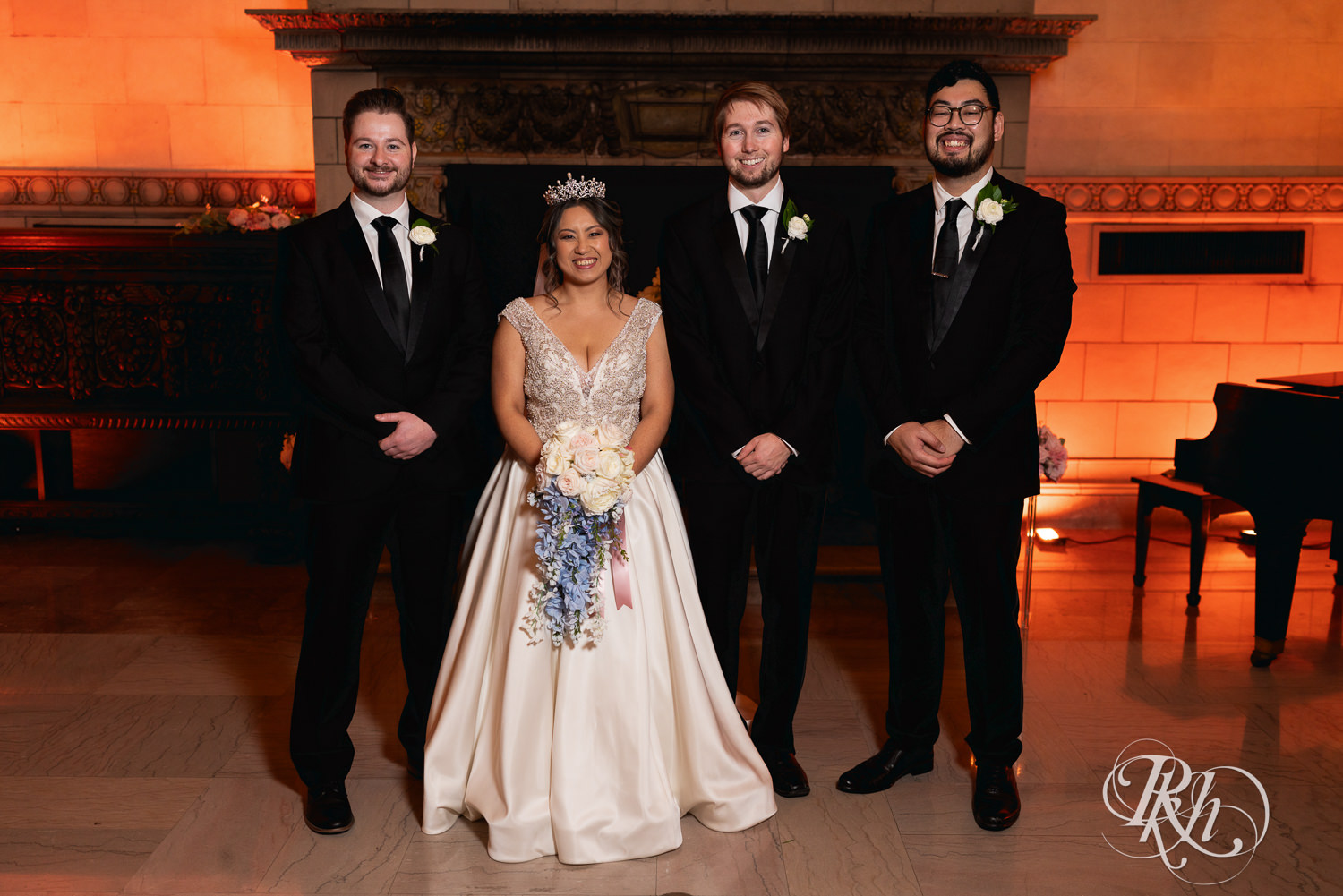Hmong bride smiles with wedding party at the Saint Paul Athletic Club in Saint Paul, Minnesota.
