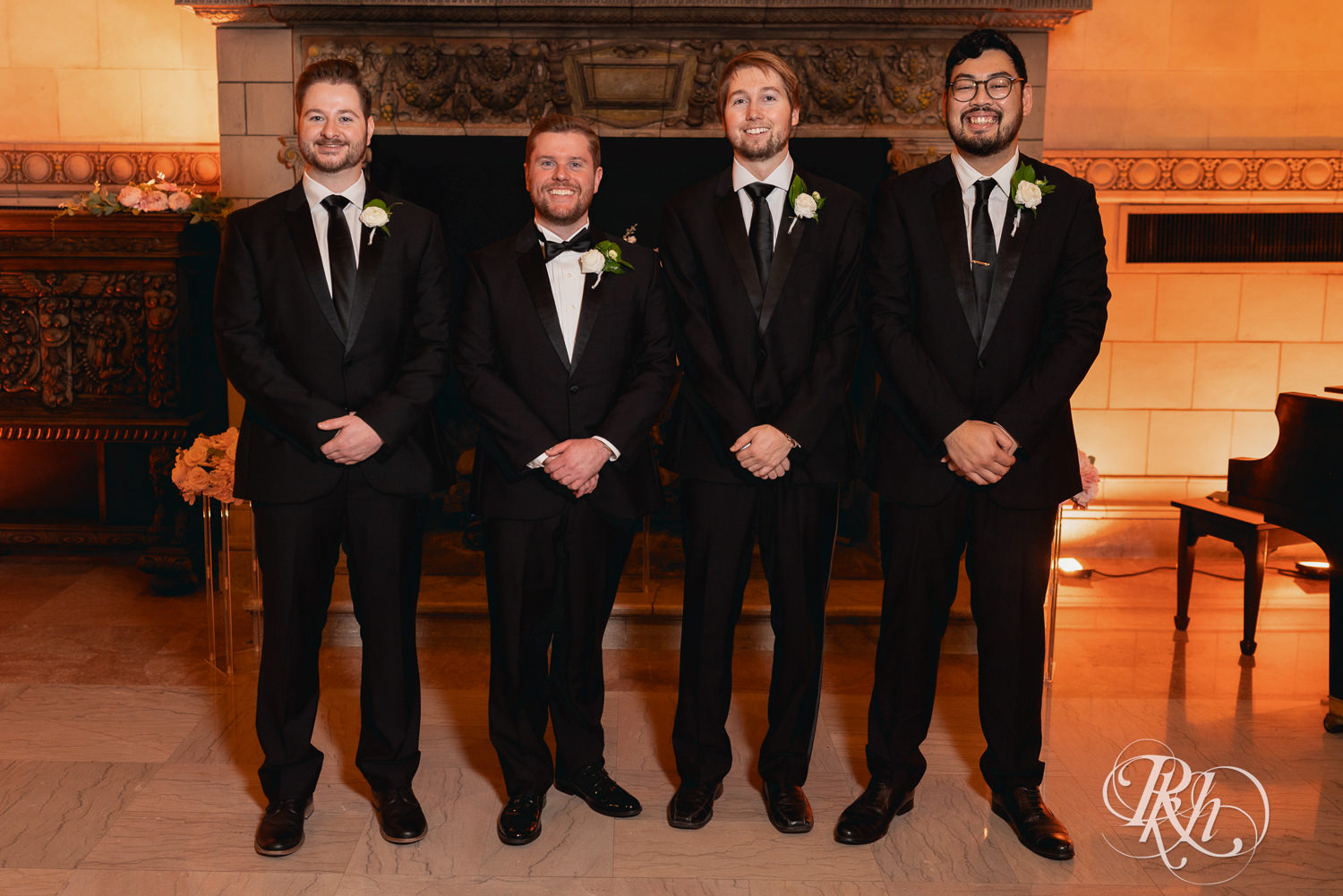 Groom smiles with wedding party at the Saint Paul Athletic Club in Saint Paul, Minnesota.
