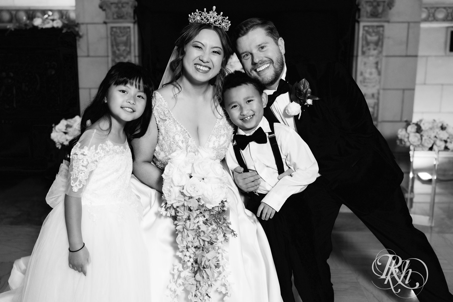 Hmong bride and groom smile with wedding party at the Saint Paul Athletic Club in Saint Paul, Minnesota.