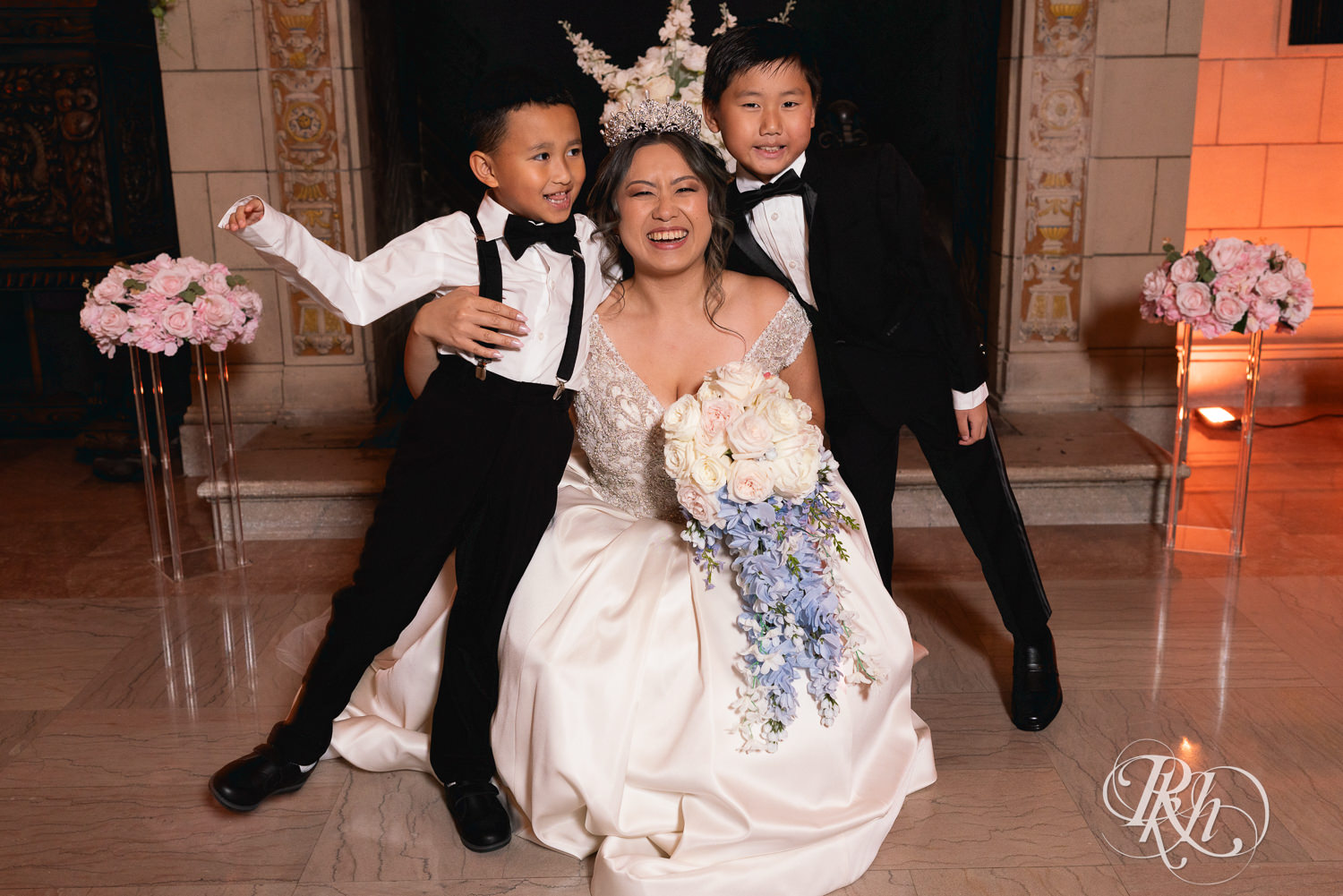 Hmong bride and groom smile with wedding party at the Saint Paul Athletic Club in Saint Paul, Minnesota.