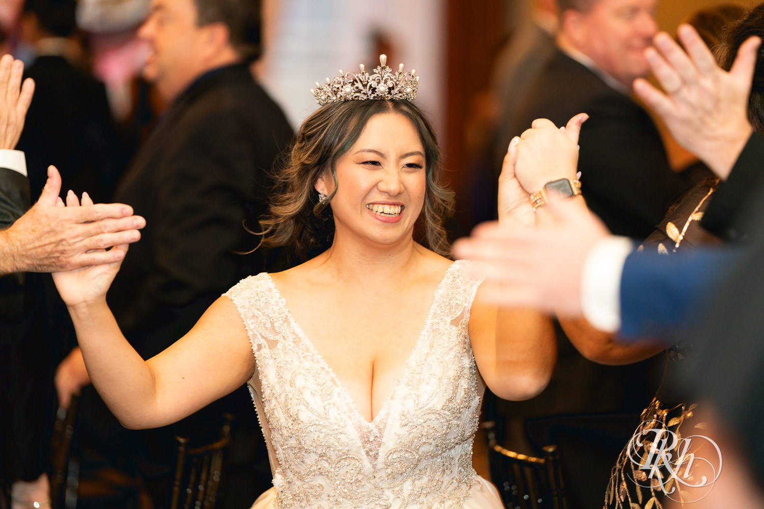 Hmong bride and groom enter wedding reception at the Saint Paul Athletic Club in Saint Paul, Minnesota.