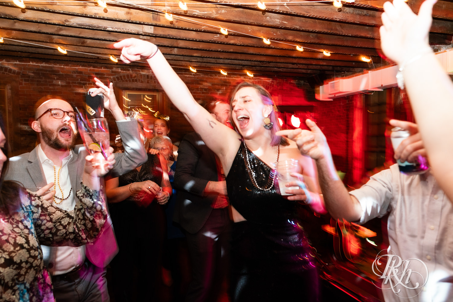 Guests dance during wedding reception at Gatherings at Station 10 in Saint Paul, Minnesota.