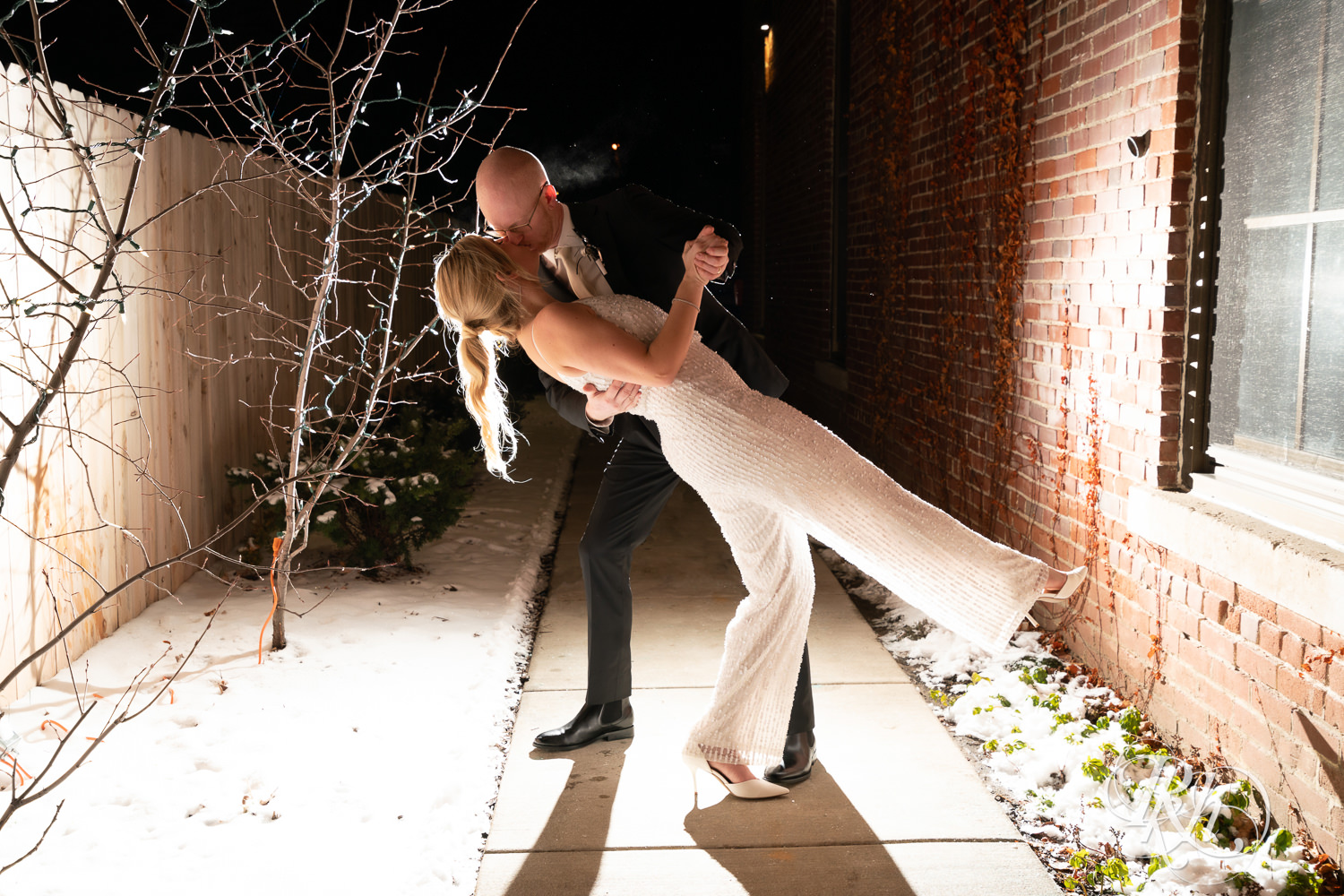 Bride and groom kiss during night photography at Gatherings at Station 10 in Saint Paul, Minnesota.