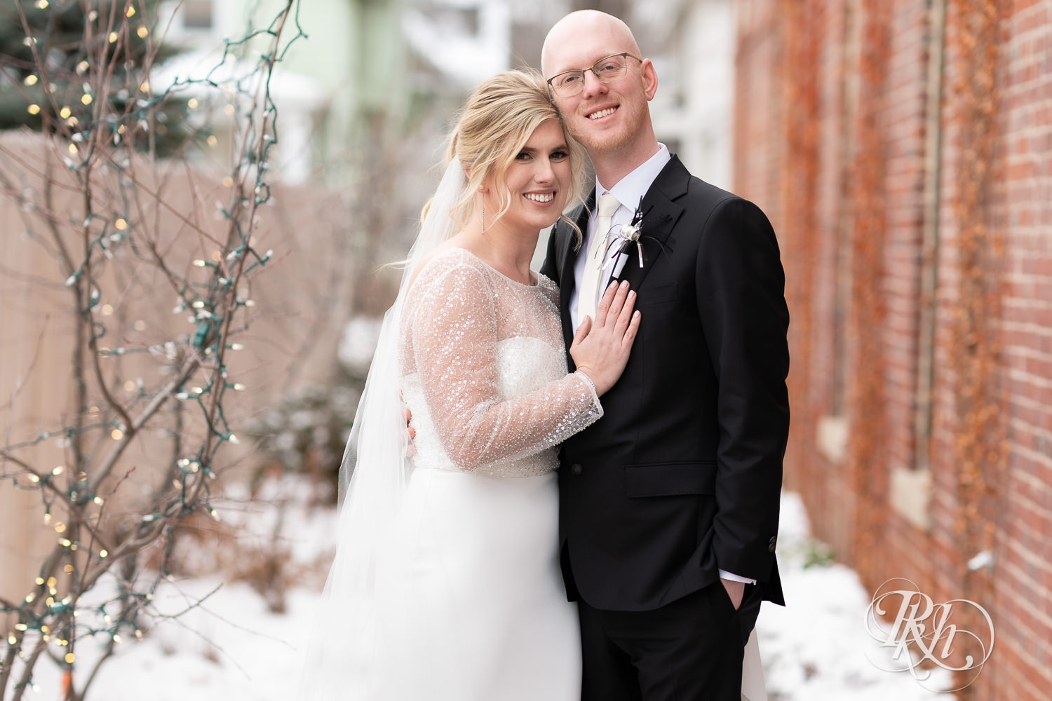 Bride and groom smile during winter wedding at Gatherings at Station 10 in Saint Paul, Minnesota.