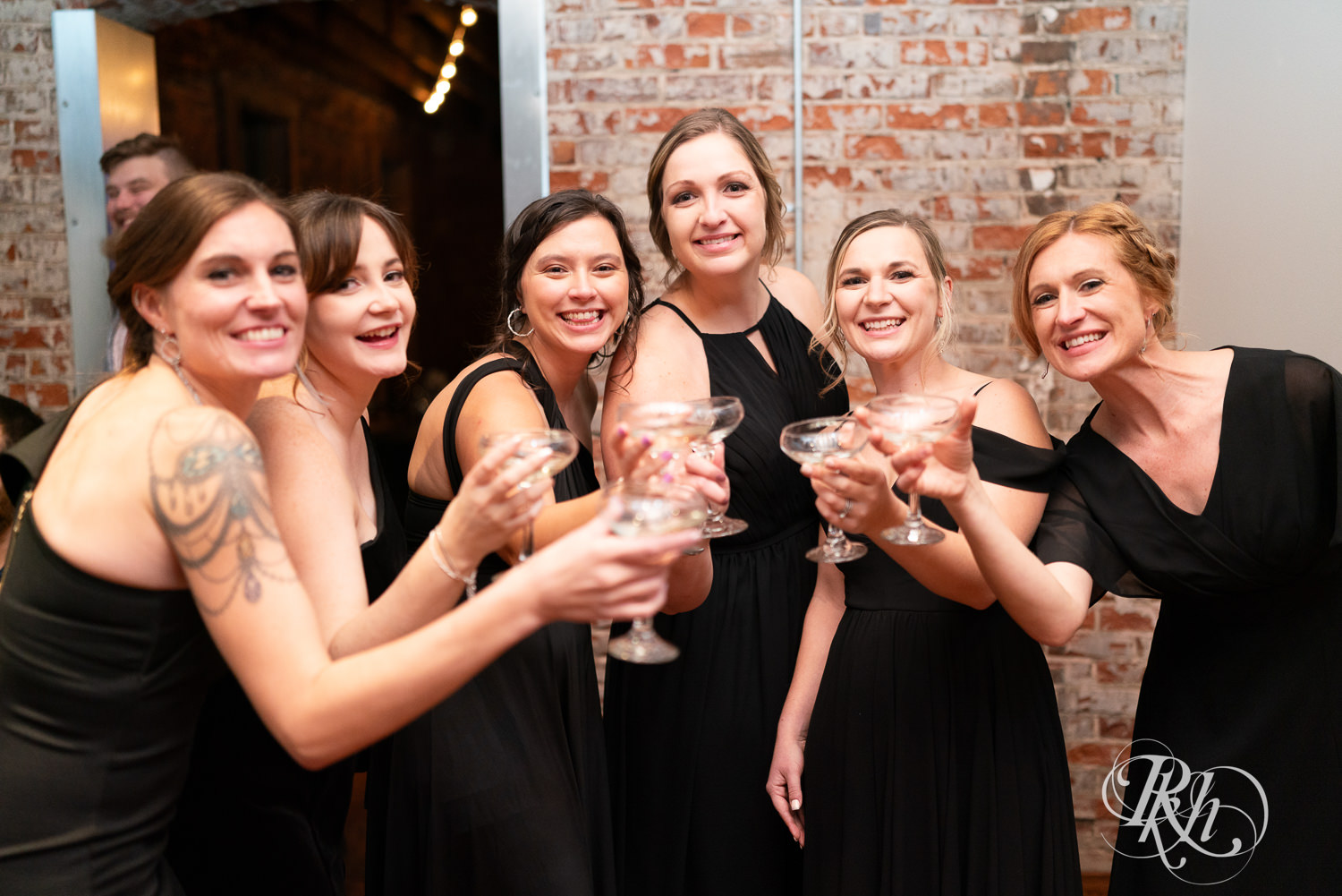 Bridesmaids toast during wedding reception at Gatherings at Station 10 in Saint Paul, Minnesota.