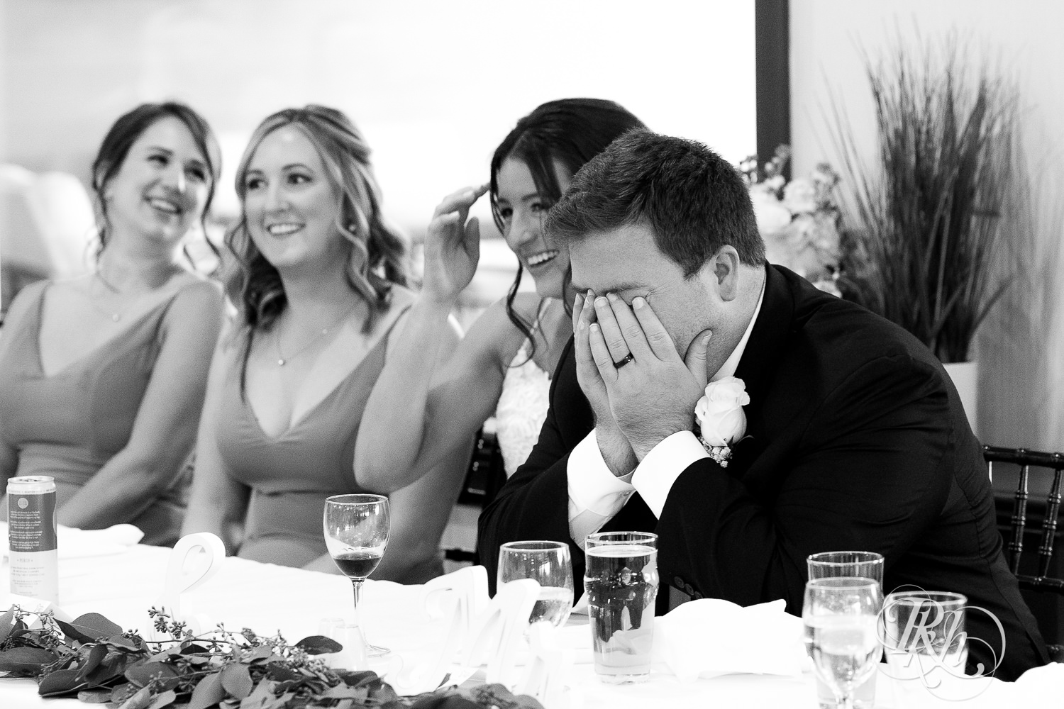 Bride and groom laugh during wedding reception at Olympic Hills Golf Club in Eden Prairie, Minnesota.