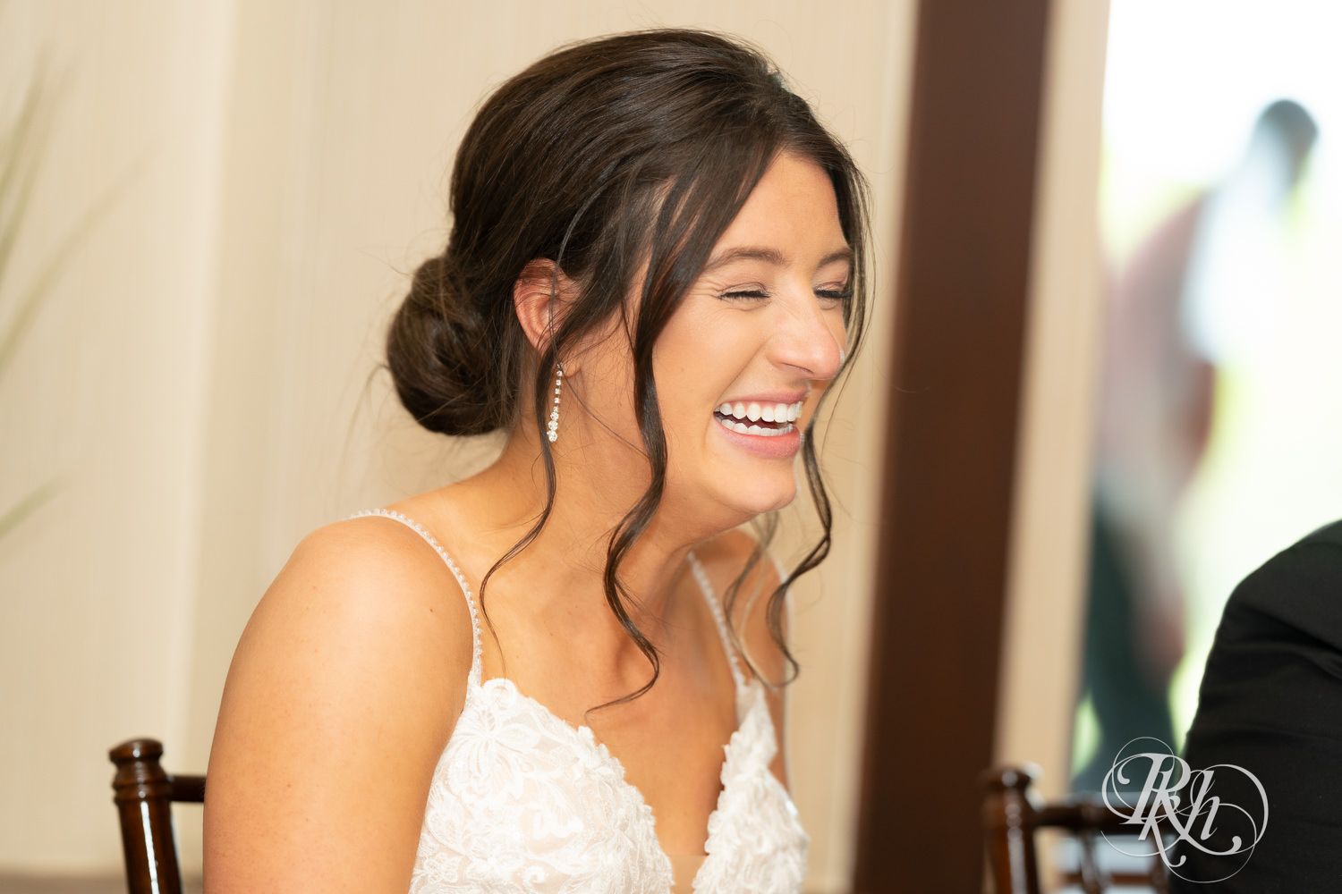 Bride and groom laugh during wedding reception at Olympic Hills Golf Club in Eden Prairie, Minnesota.