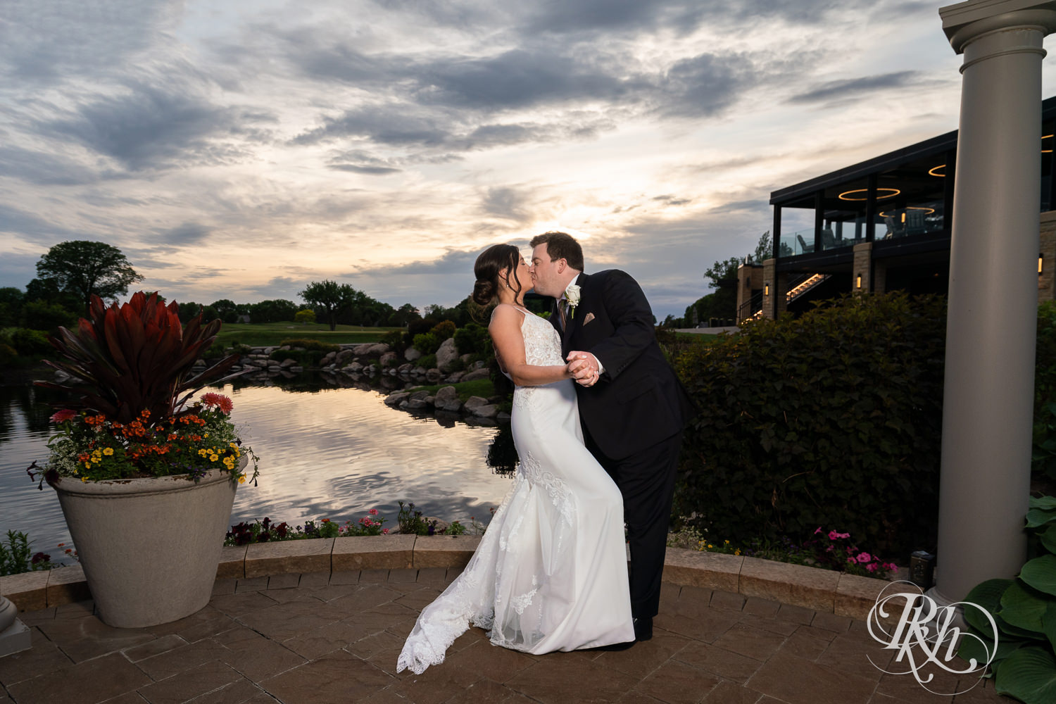 Bride and groom kiss at sunset at Olympic Hills Golf Club in Eden Prairie, Minnesota.