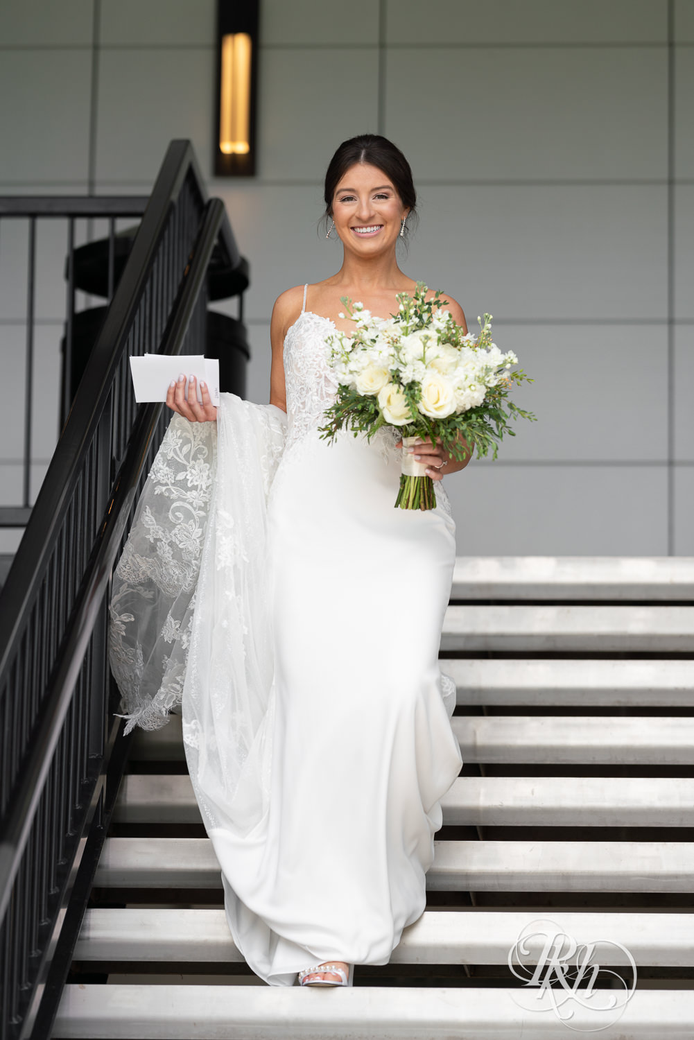 Bride walking down the stairs at Olympic Hills Golf Club in Eden Prairie, Minnesota.