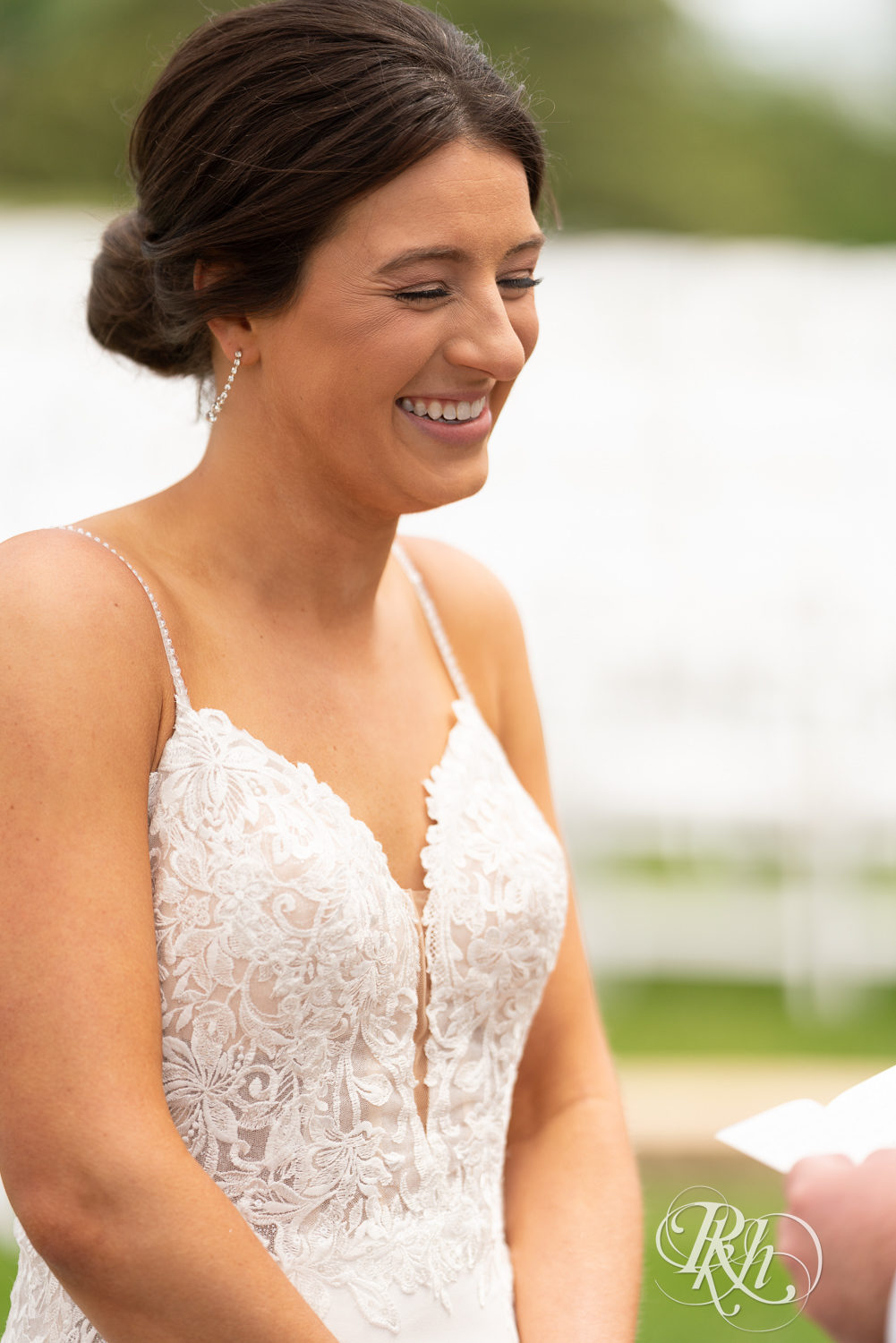 Bride laughs during a first look at Olympic Hills Golf Club in Eden Prairie, Minnesota.