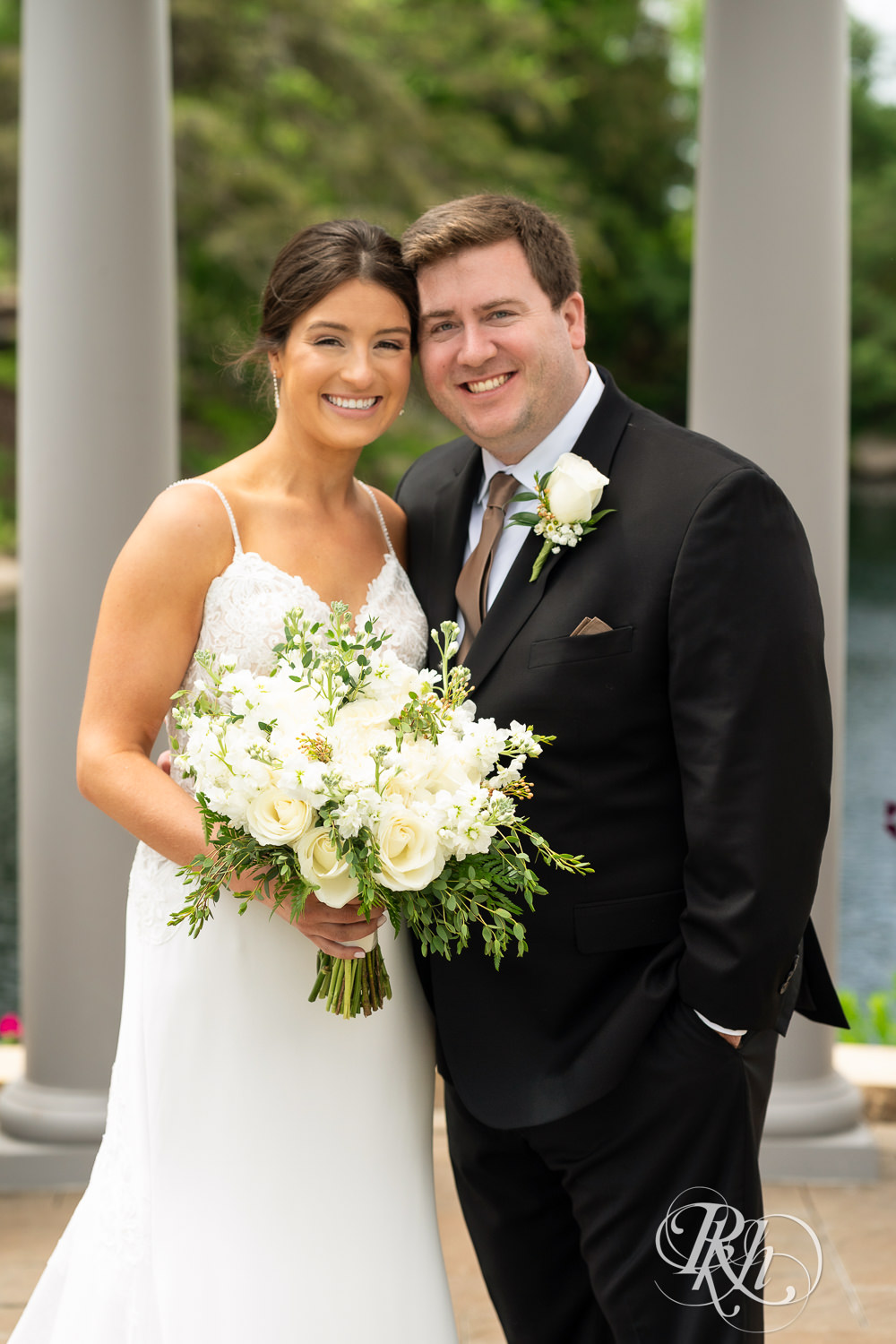 Bride and groom smile on wedding day at Olympic Hills Golf Club in Eden Prairie, Minnesota.