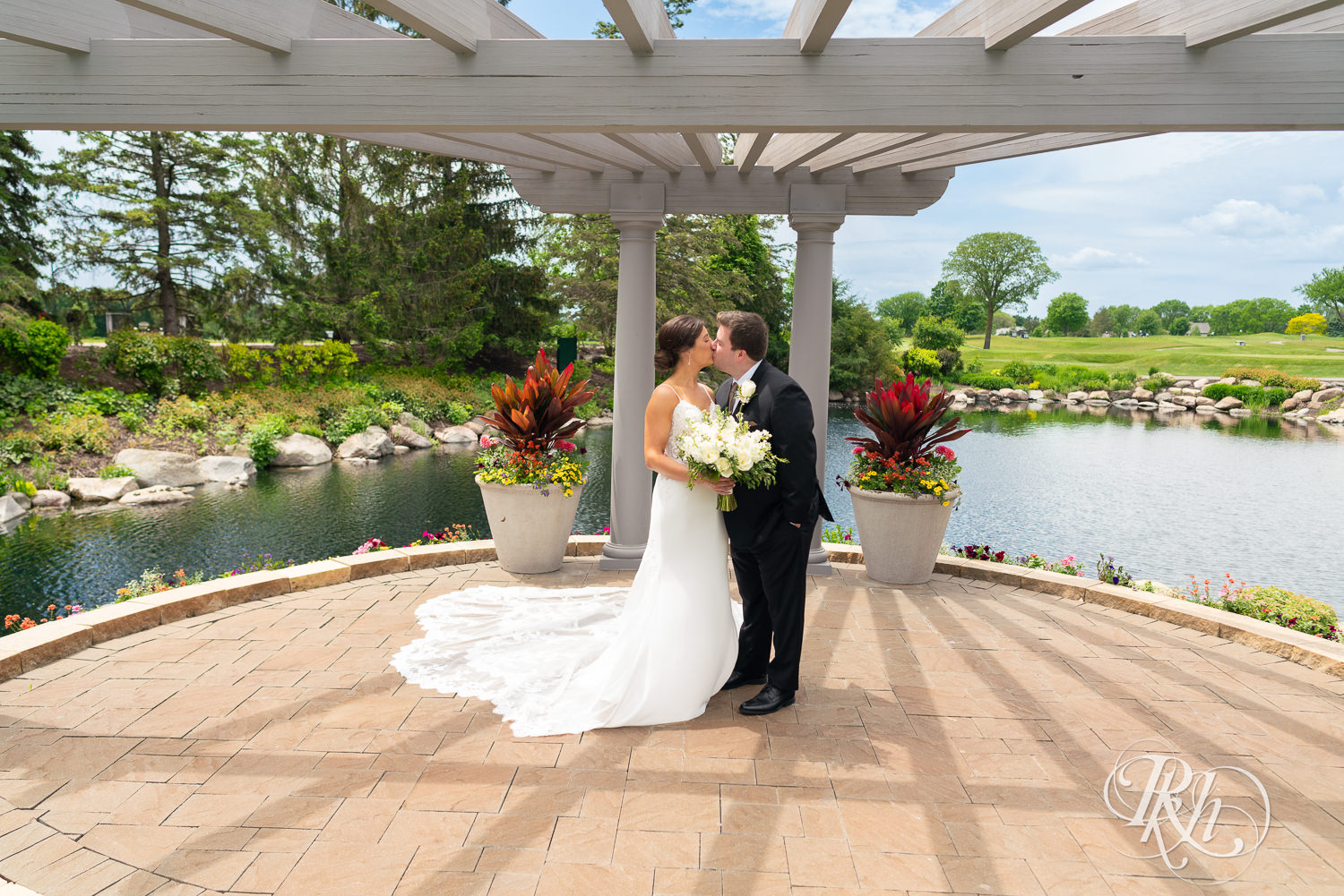 Bride and groom smile on wedding day at Olympic Hills Golf Club in Eden Prairie, Minnesota.