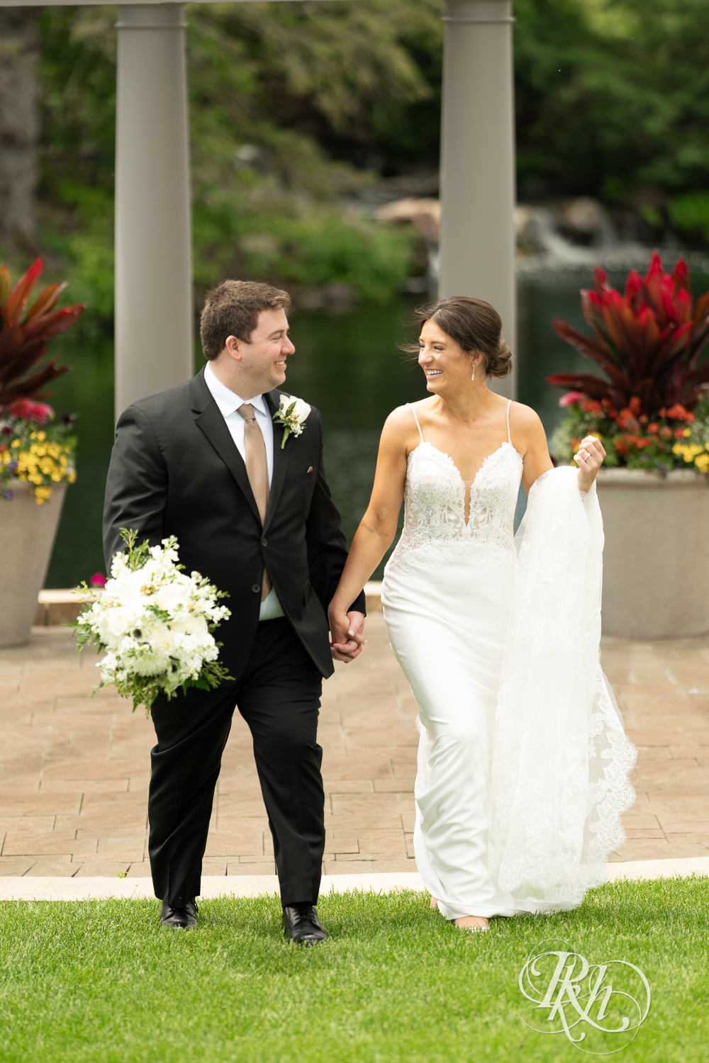 Bride and groom smile on wedding day at Olympic Hills Golf Club in Eden Prairie, Minnesota.