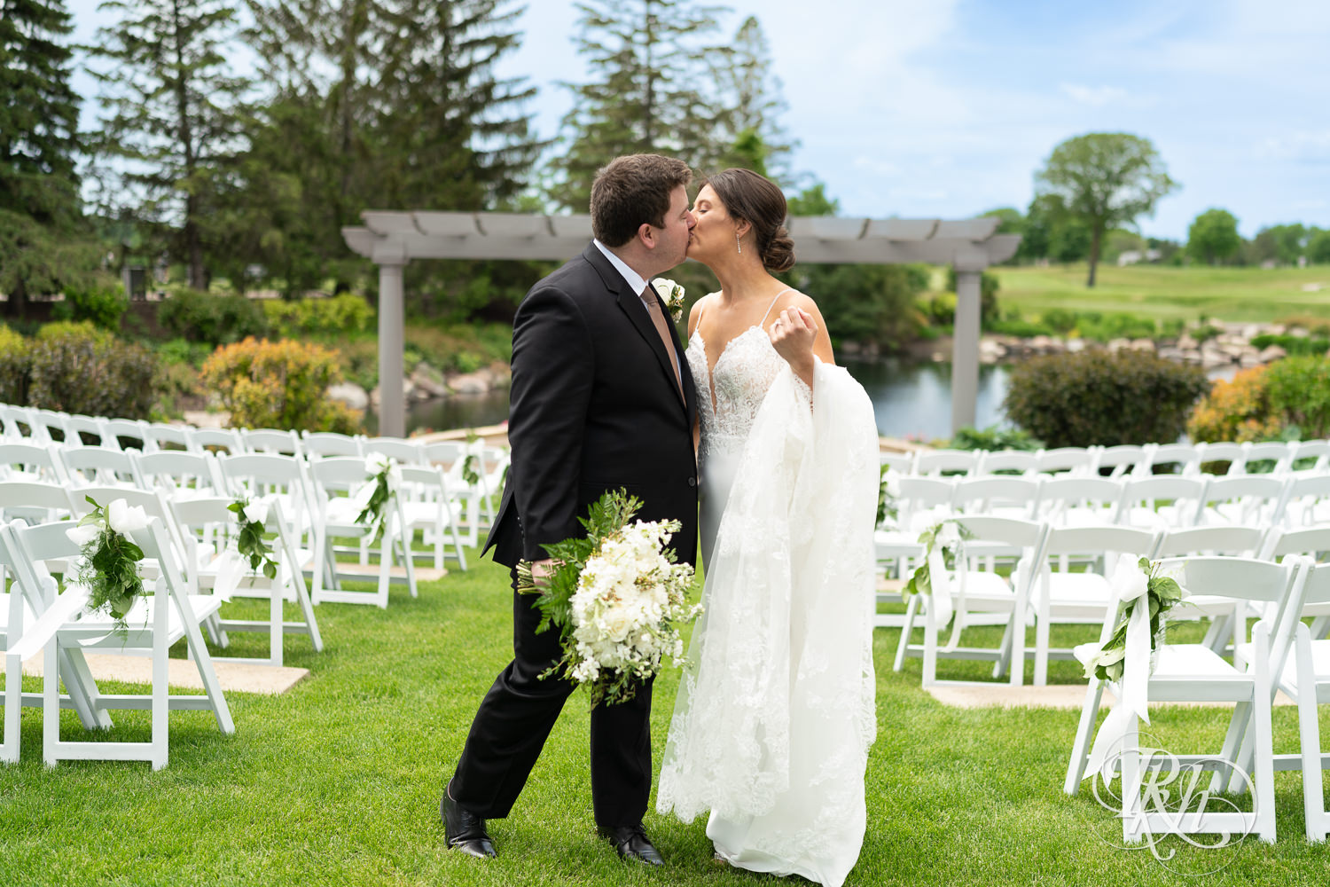 Bride and groom kiss on wedding day at Olympic Hills Golf Club in Eden Prairie, Minnesota.