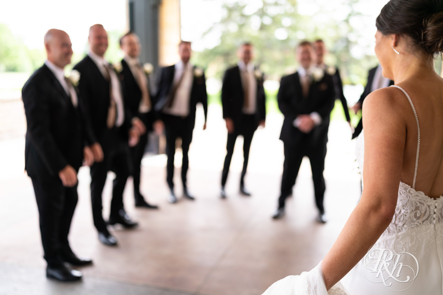 Bride shares first look with groomsmen at Olympic Hills Golf Club in Eden Prairie, Minnesota.