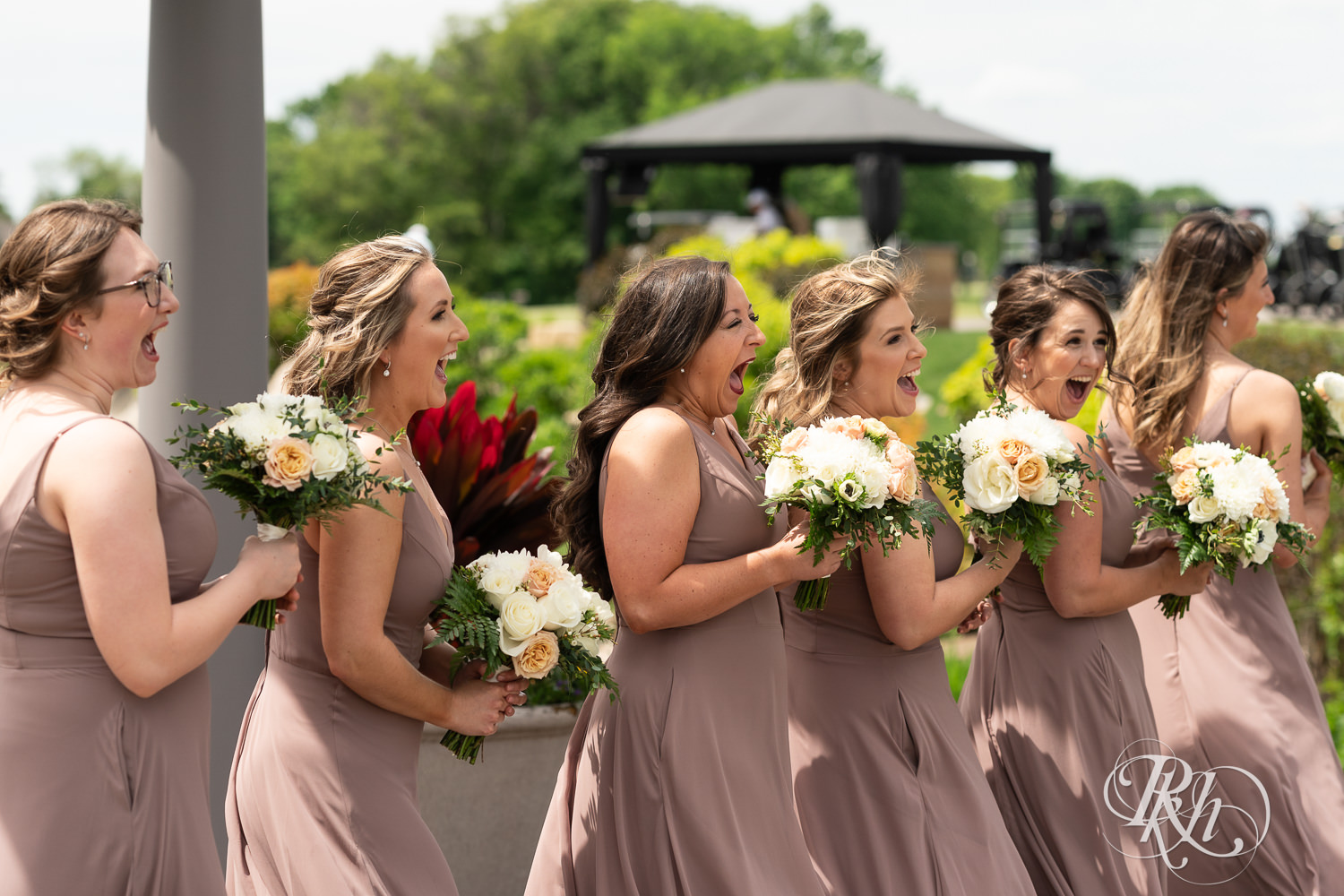 Bride shares first look with bridesmaids at Olympic Hills Golf Club in Eden Prairie, Minnesota.