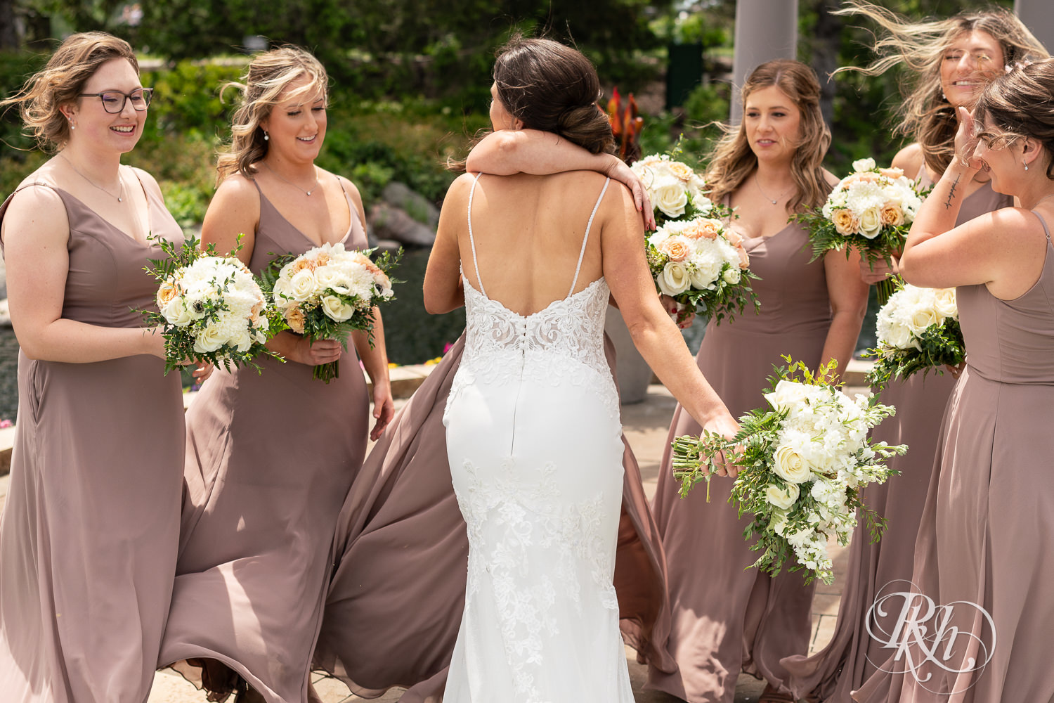 Bride shares first look with bridesmaids at Olympic Hills Golf Club in Eden Prairie, Minnesota.