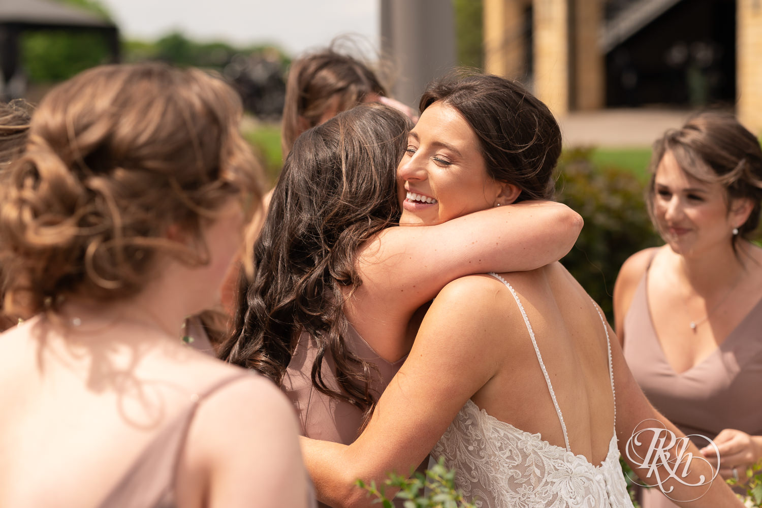 Bride shares first look with bridesmaids at Olympic Hills Golf Club in Eden Prairie, Minnesota.