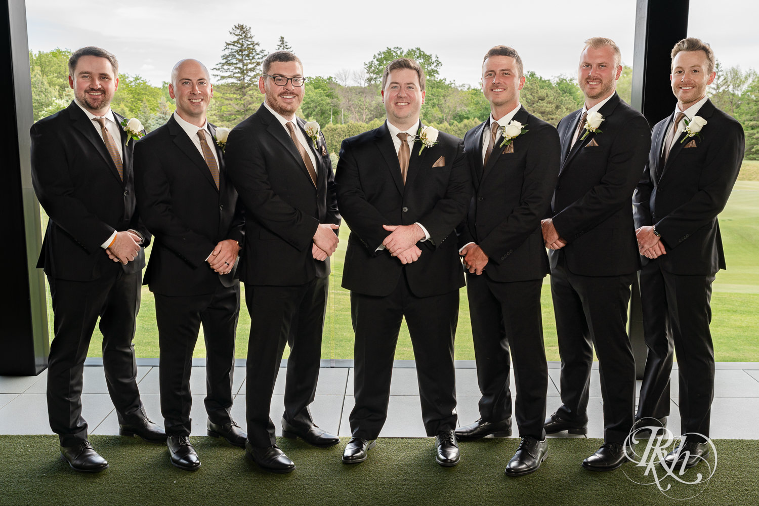 Bride and groom pose with wedding party at Olympic Hills Golf Club in Eden Prairie, Minnesota.