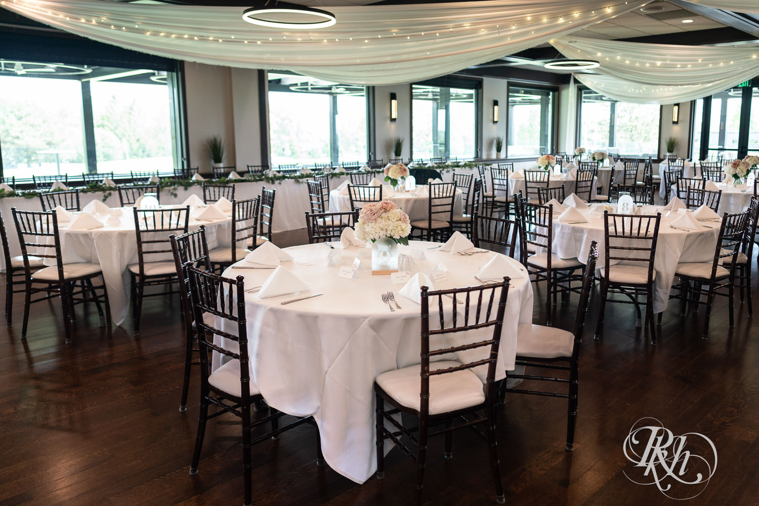 Indoor wedding reception setup at Olympic Hills Golf Club in Eden Prairie, Minnesota.