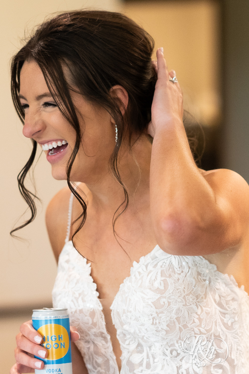 Bride laughs during wedding reception at Olympic Hills Golf Club in Eden Prairie, Minnesota.