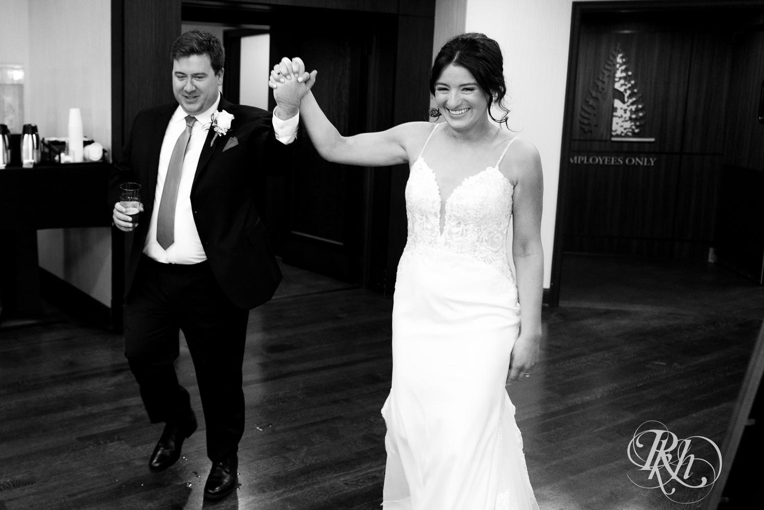 Bride and groom cheer during grand entrance at Olympic Hills Golf Club in Eden Prairie, Minnesota.