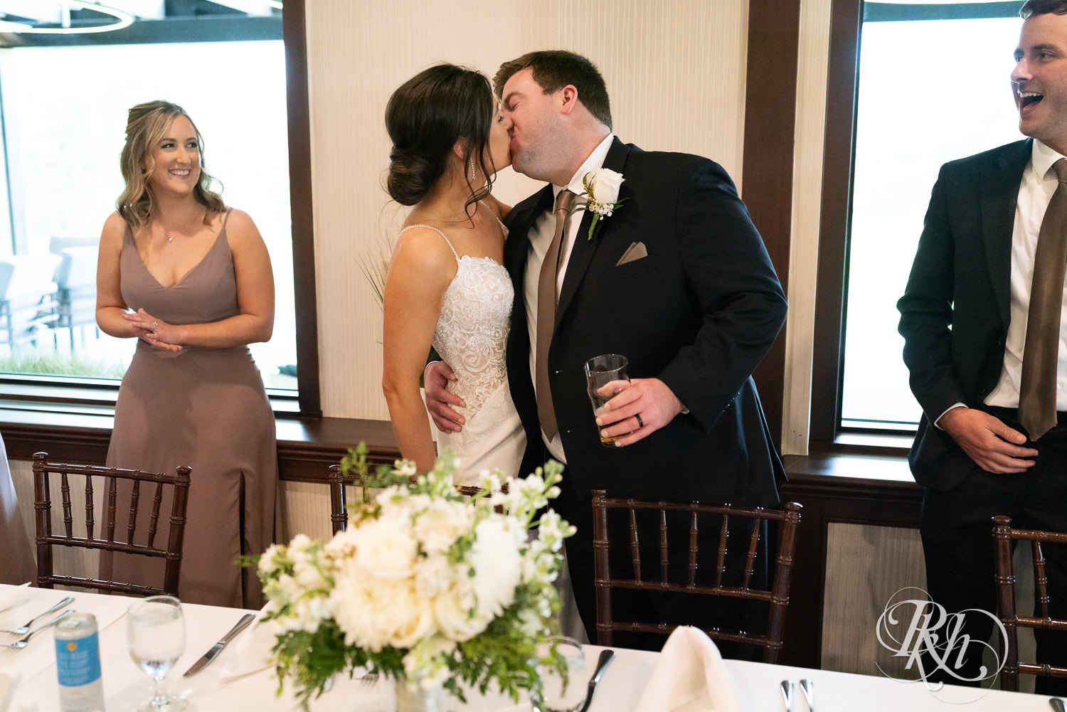 Bride and groom kiss during wedding reception at Olympic Hills Golf Club in Eden Prairie, Minnesota.