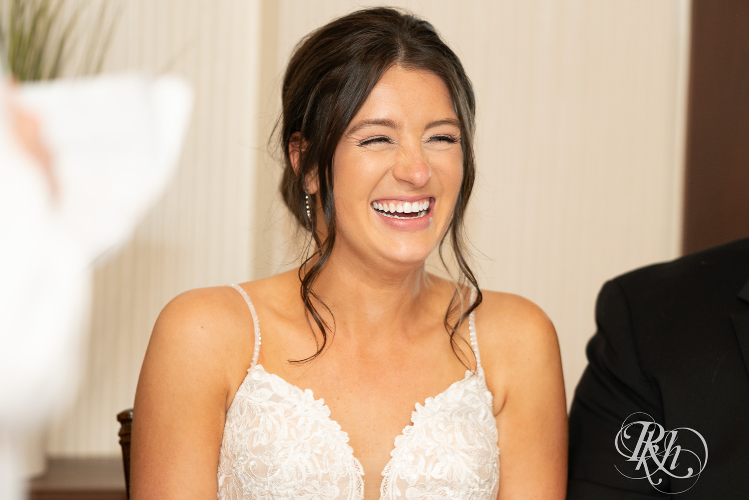 Bride and groom laugh during wedding reception at Olympic Hills Golf Club in Eden Prairie, Minnesota.