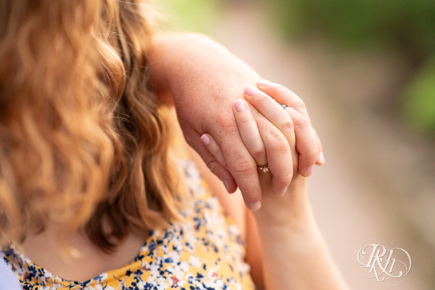 Couple holds hands at Centennial Lakes Park in Edina, Minnesota.