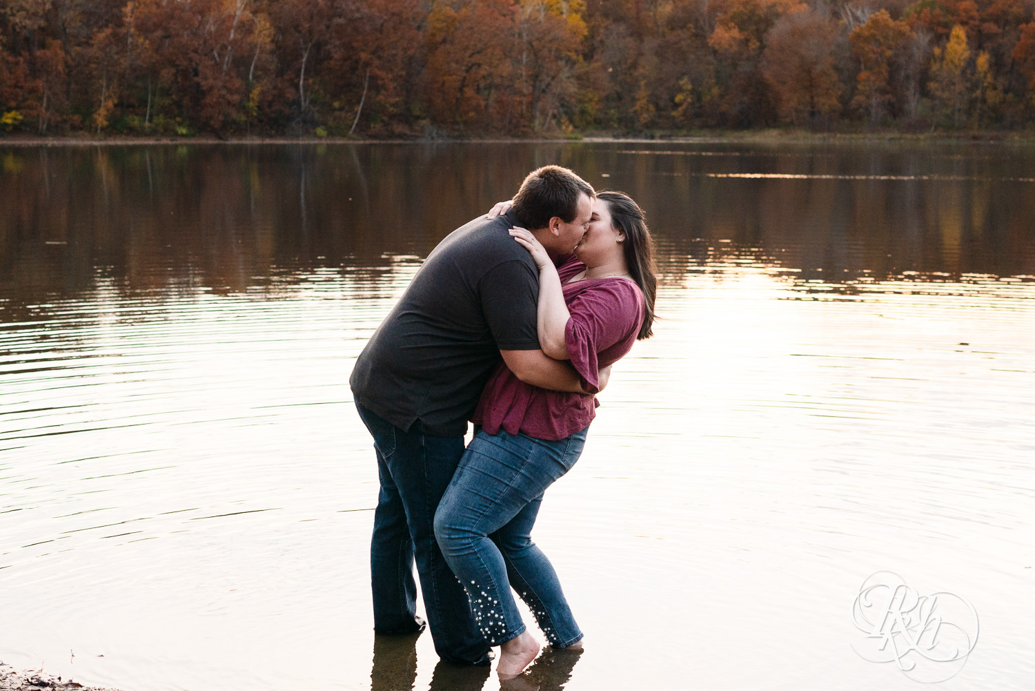Plus size man and woman kiss in the lake at Lebanon Hills Regional Park in Eagan, Minnesota.
