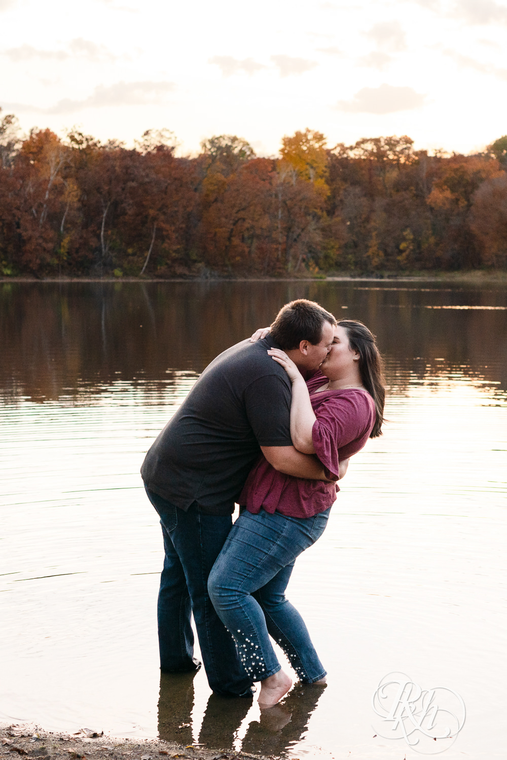 Plus size man and woman kiss in the lake at Lebanon Hills Regional Park in Eagan, Minnesota.