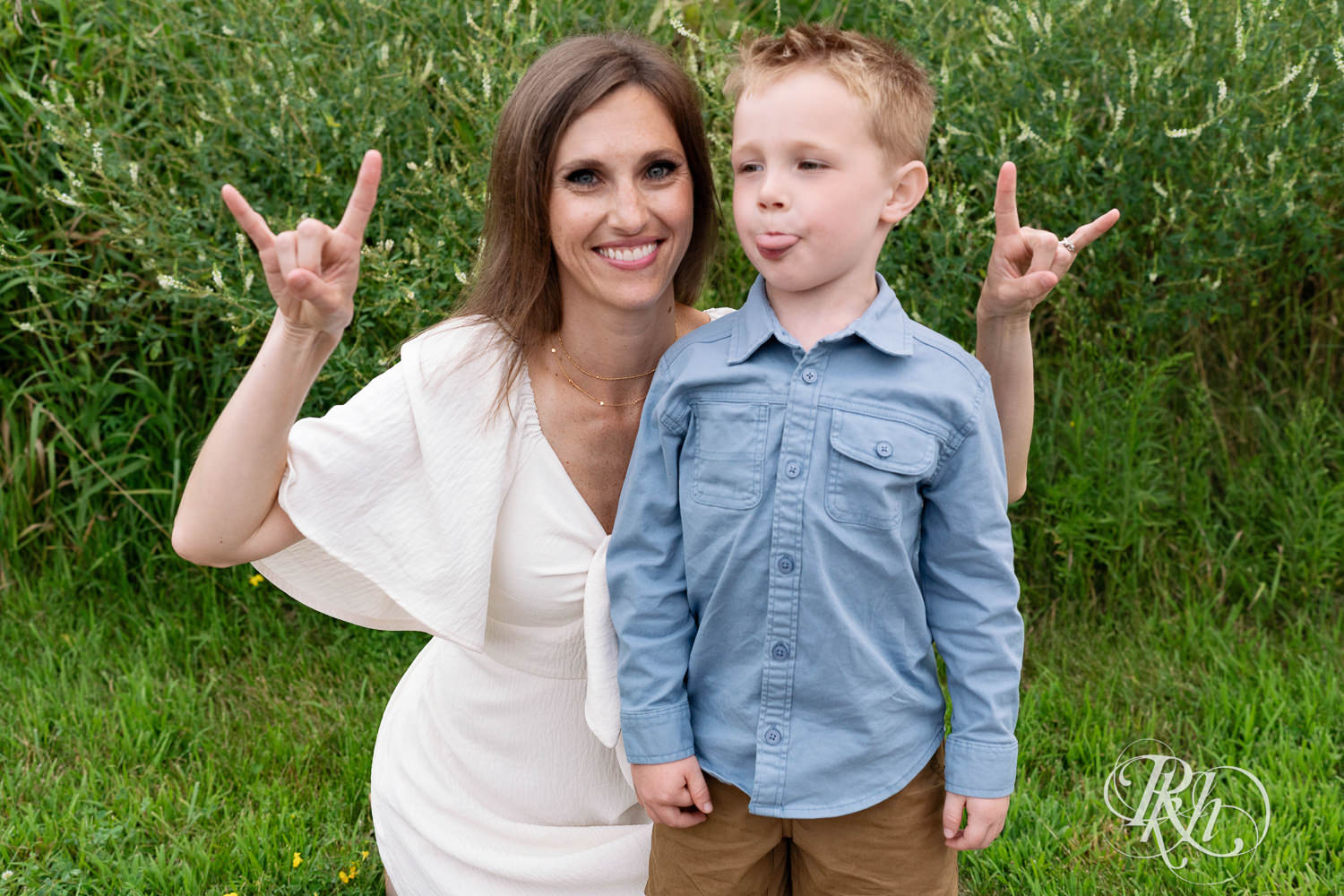 Woman in white dress and her son dressed in blue smile in field in Eagan, Minnesota.