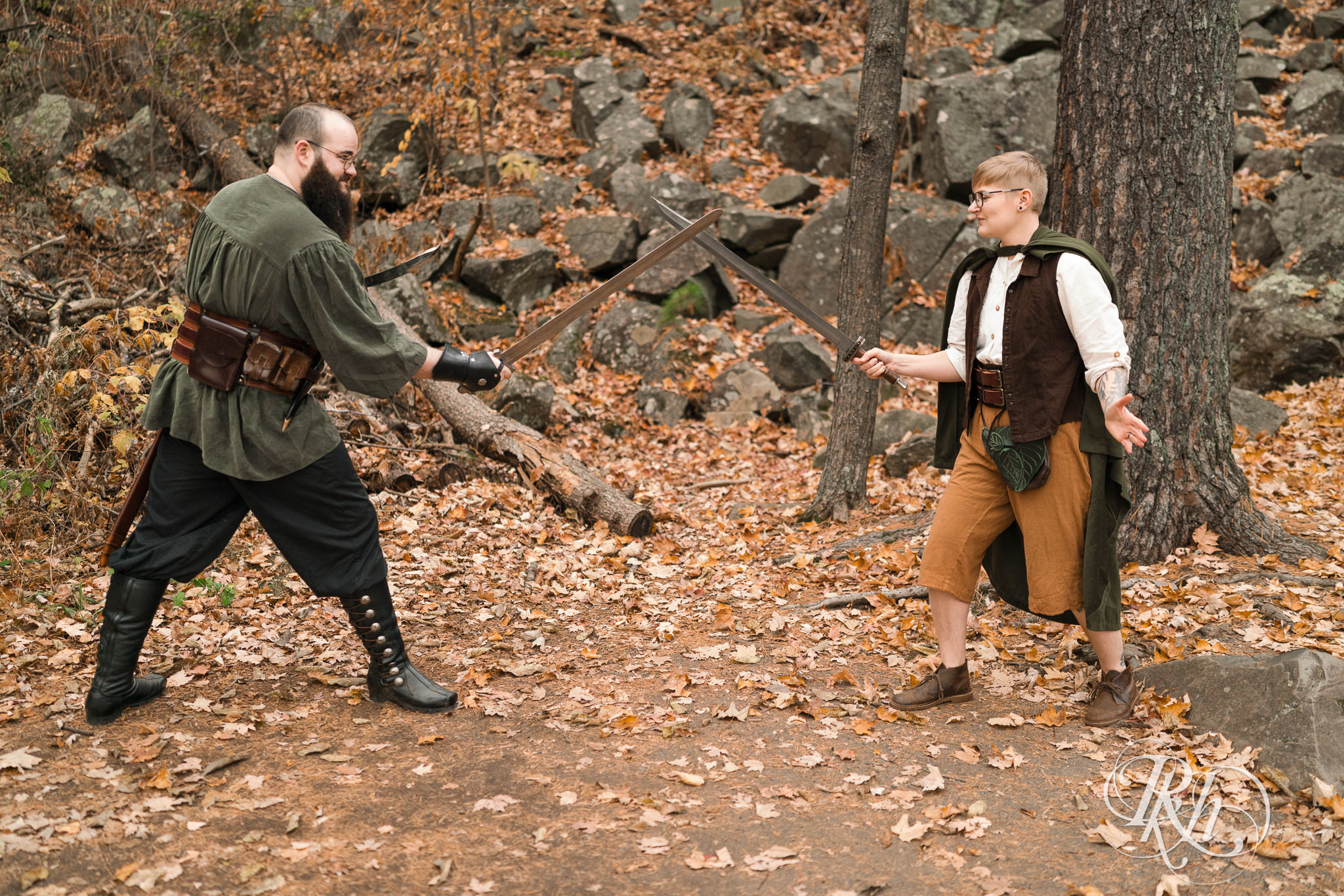 Man and non binary person in Renaissance outfits sword fight in Taylor's Falls, Minnesota.