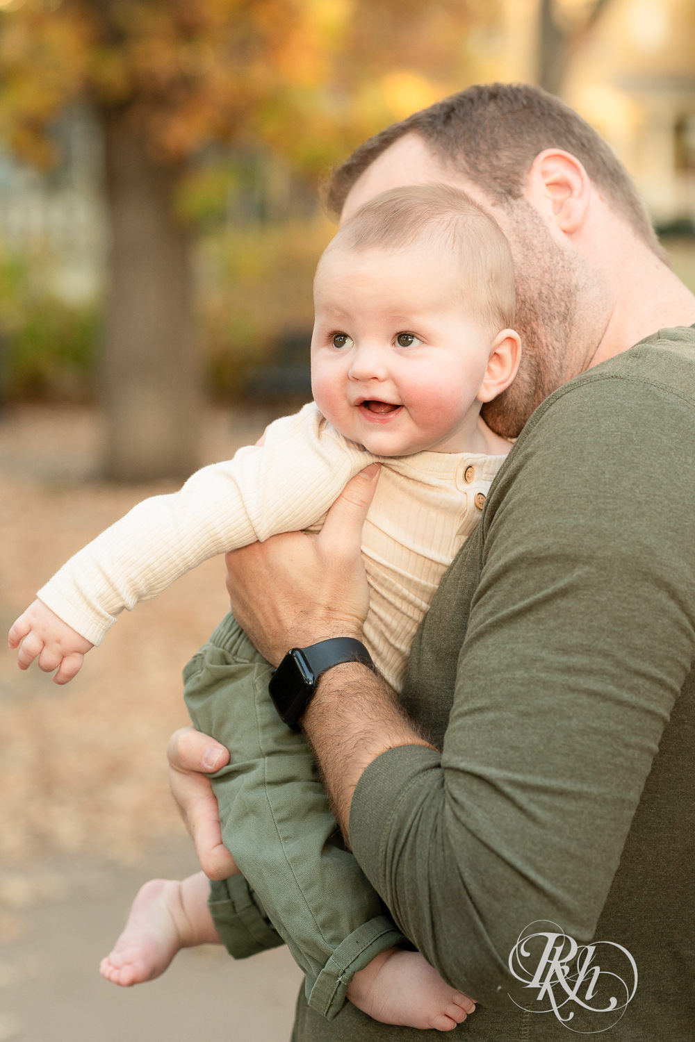  Baby smiles with dad at Irvine Park in Saint Paul, Minnesota.