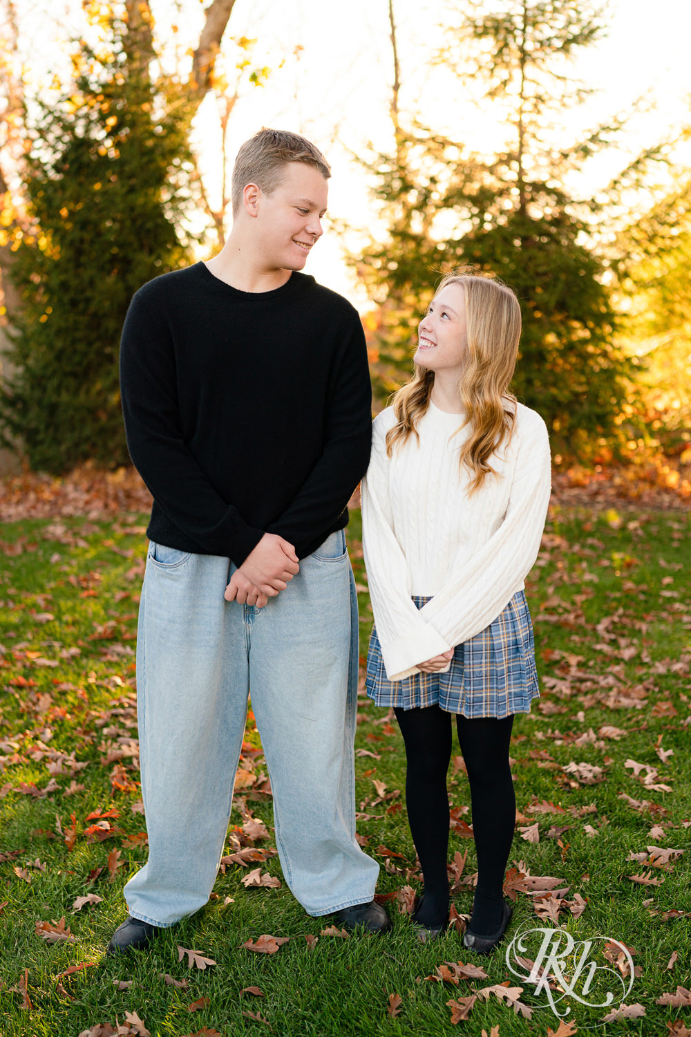 Brother and sister smile during sunset family photos in Wayzata, Minnesota.