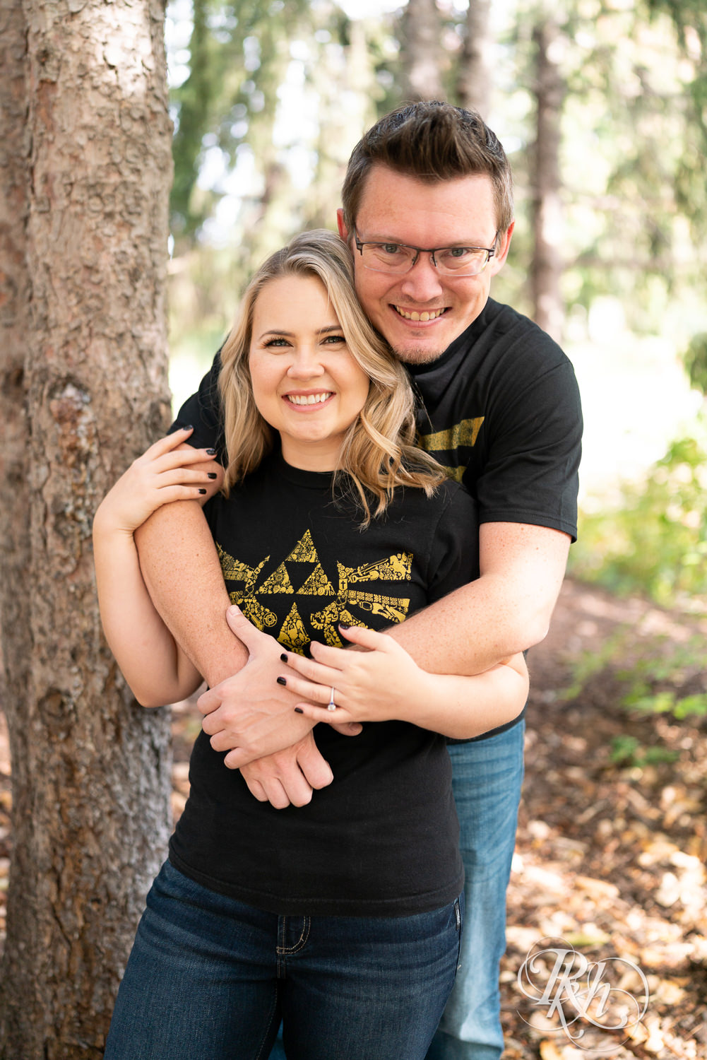 Man and woman in Zelda shirts snuggle at Centennial Lakes Park in Edina, Minnesota.