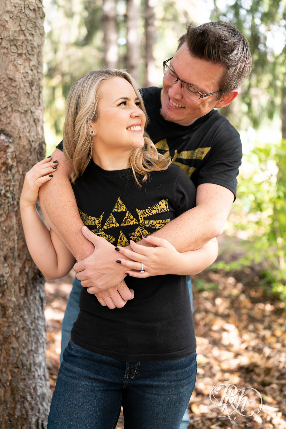 Man and woman in Zelda shirts snuggle at Centennial Lakes Park in Edina, Minnesota.