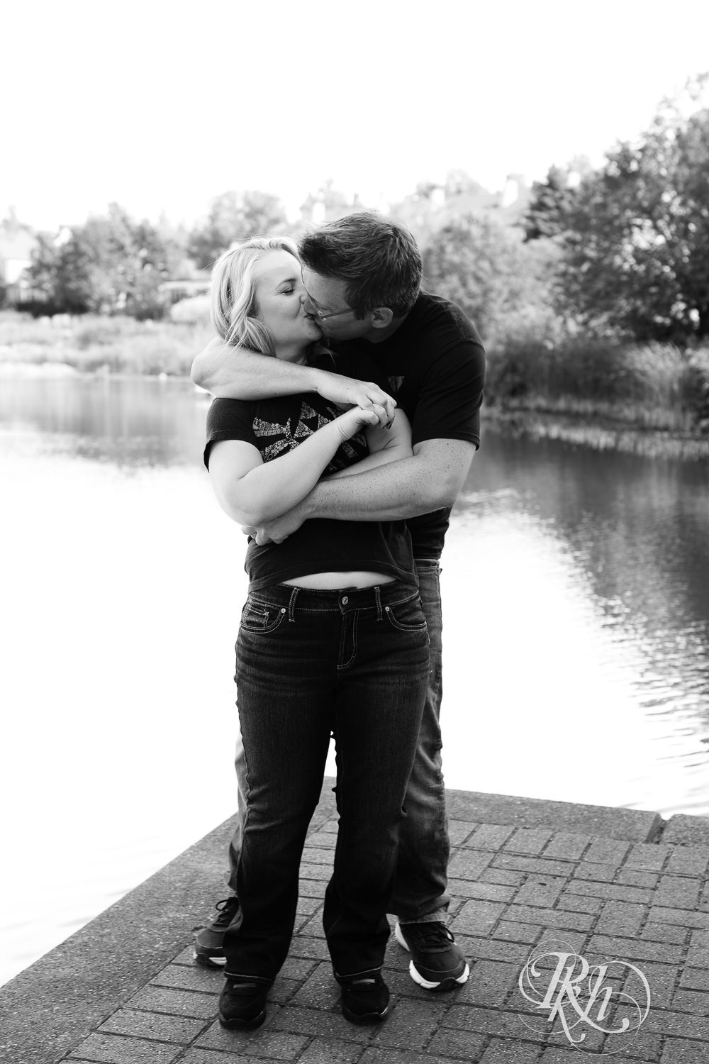 Man and woman in Zelda shirts snuggle during engagement photography at Centennial Lakes Park in Edina, Minnesota.