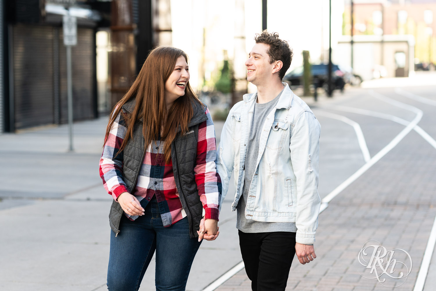 Man and woman in flannel laugh while walking down the street in Minneapolis, Minnesota.