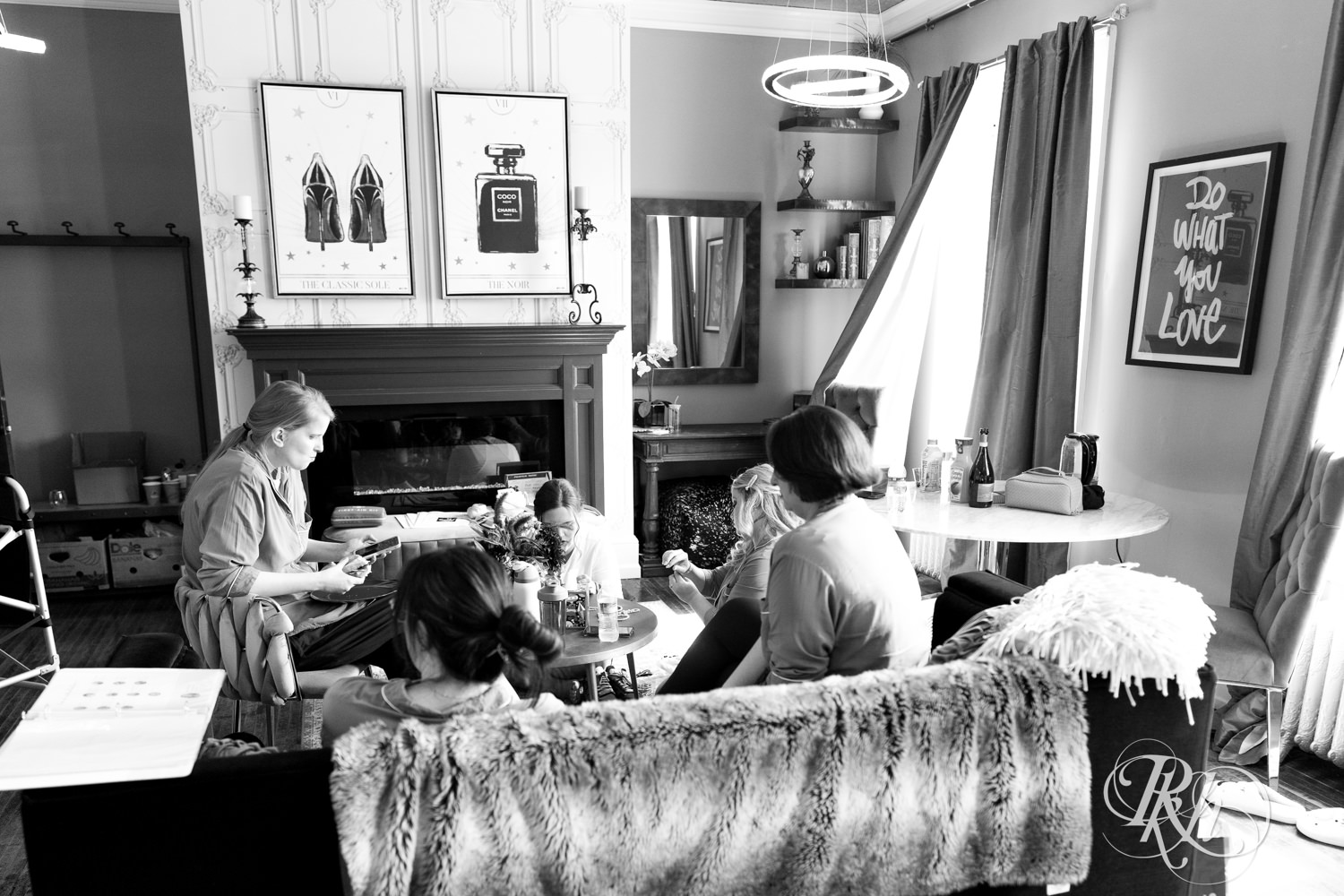 Bridesmaids sit on the couch conversing on the wedding morning at Semple Mansion in Minneapolis, Minnesota.
