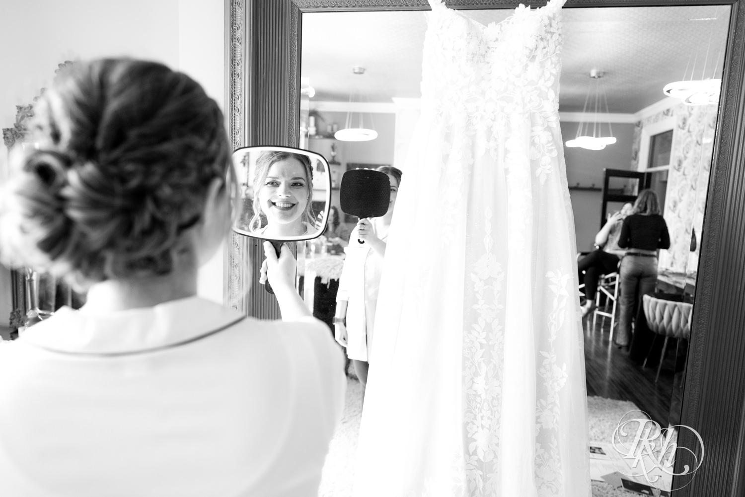 Bride looks in a handheld mirror at Semple Mansion in Minneapolis, Minnesota.