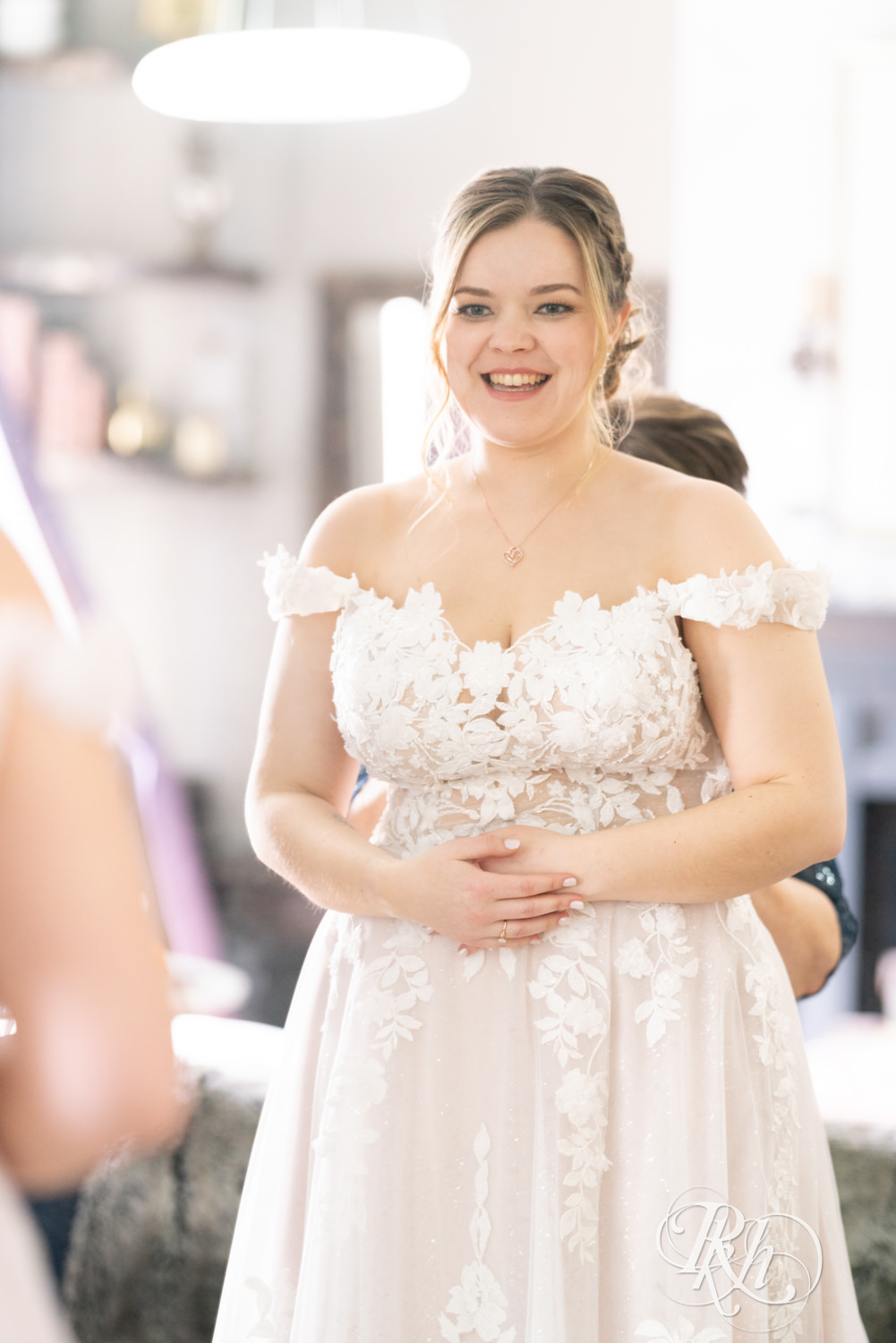 Mom helps bride get into wedding dress on wedding day at the Semple Mansion in Minneapolis, Minnesota.