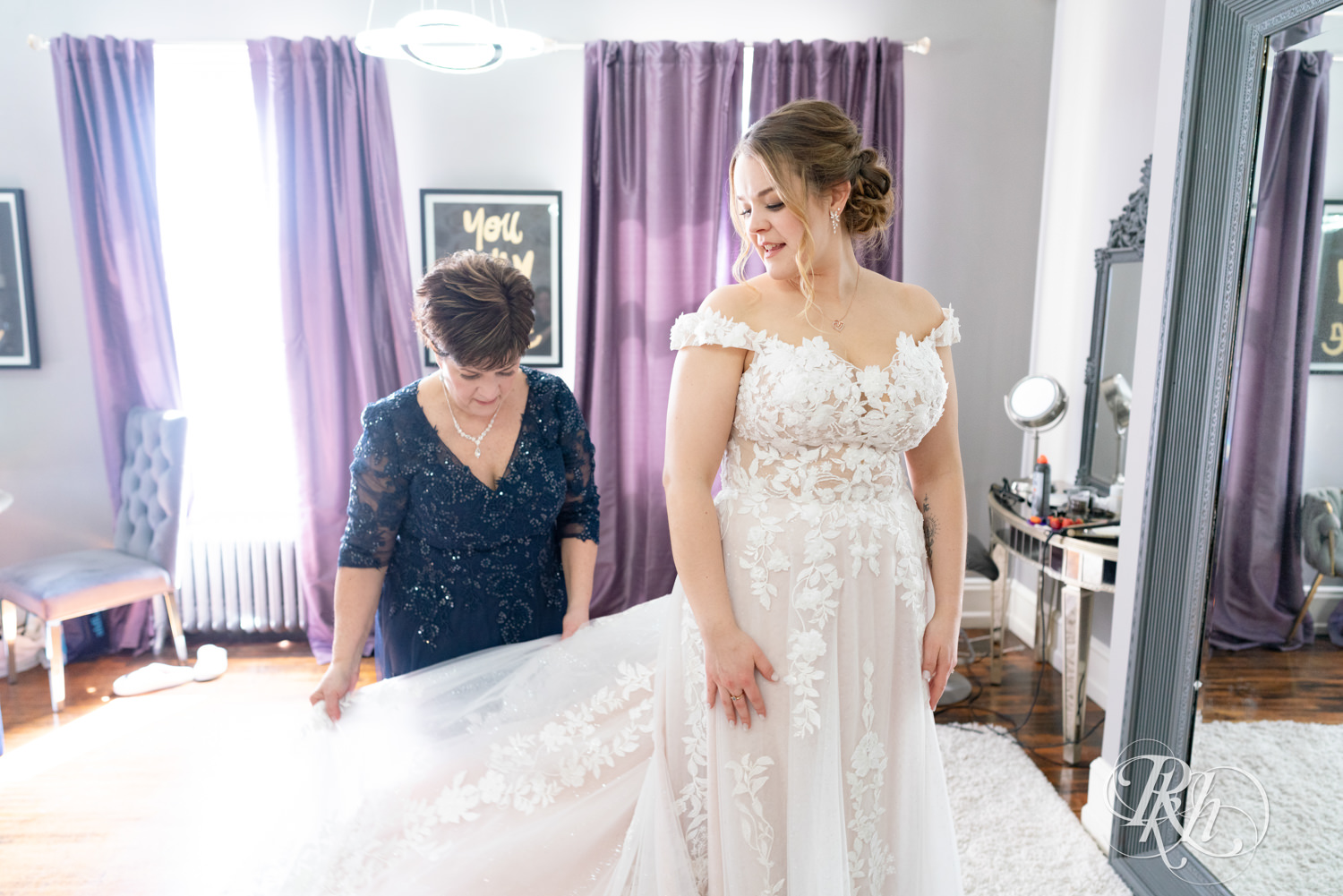 Mom helps bride get into wedding dress on wedding day at the Semple Mansion in Minneapolis, Minnesota.