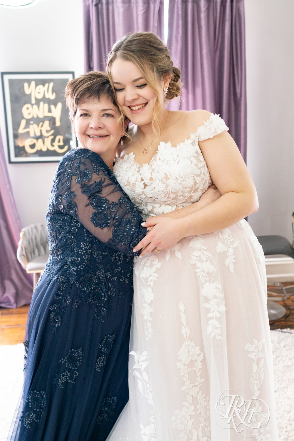 Mom hugs bride on wedding day at the Semple Mansion in Minneapolis, Minnesota.