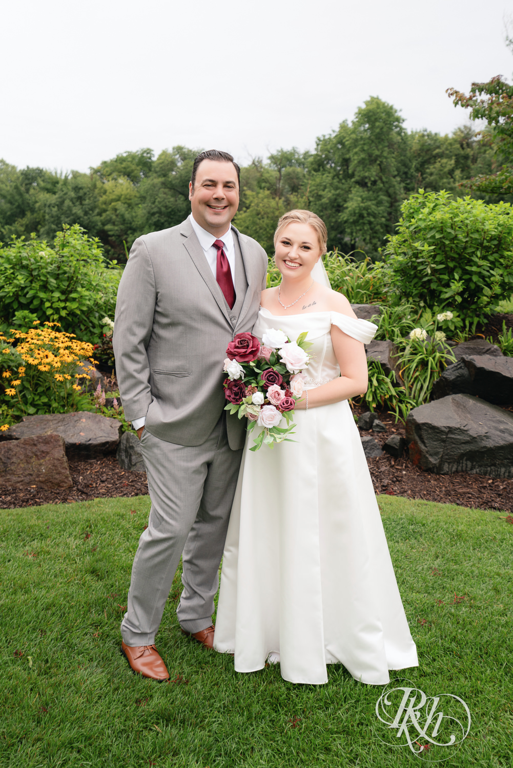Bride and groom smile on wedding day at Dellwood Country Club in Dellwood, Minnesota.