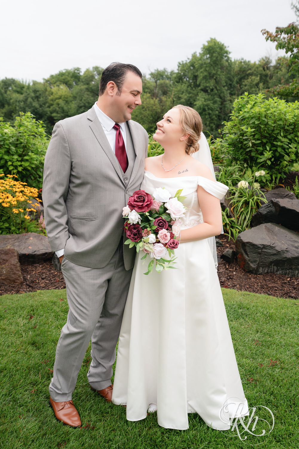 Bride and groom smile on wedding day at Dellwood Country Club in Dellwood, Minnesota.